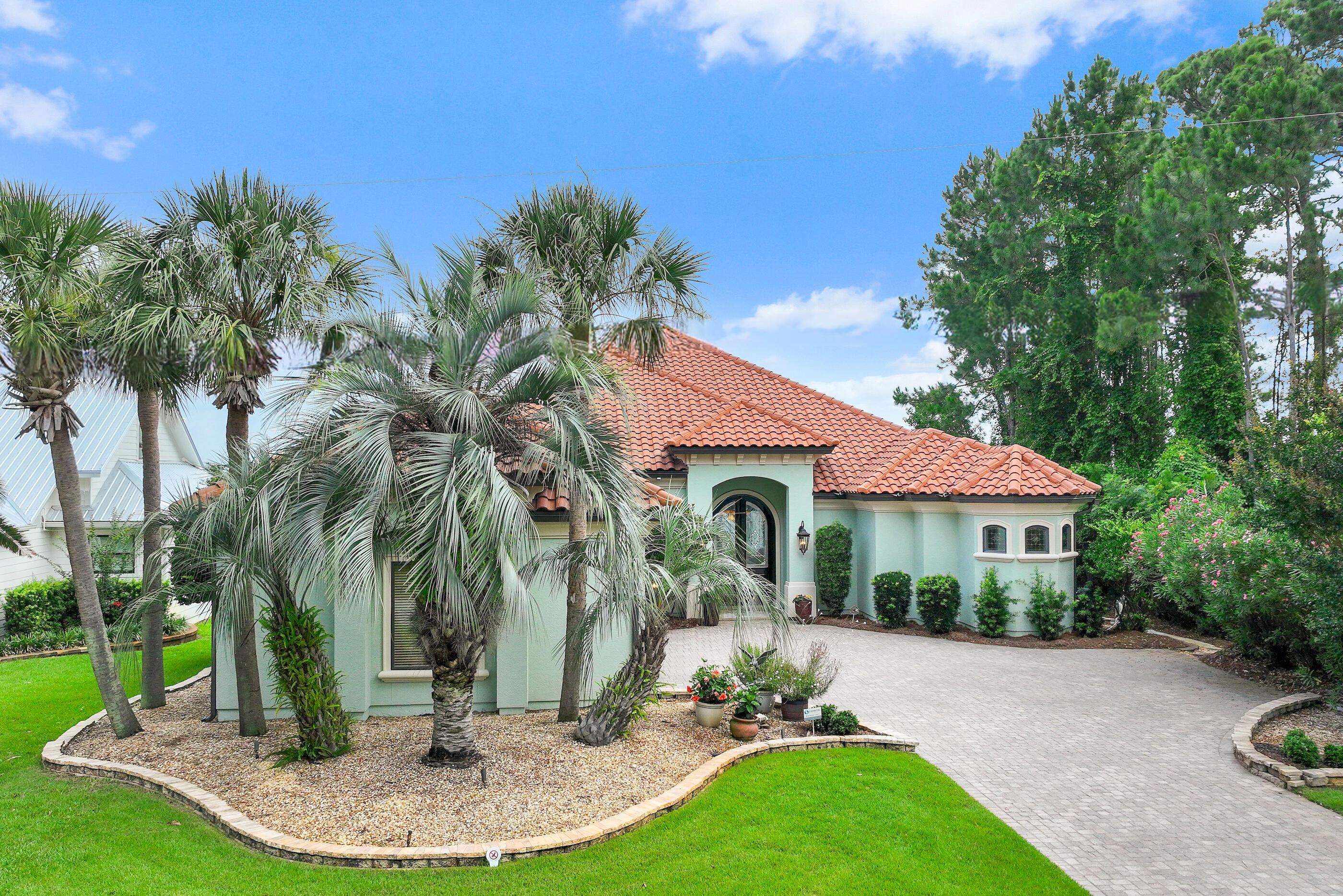 This stunning single-story home captivates with exquisite and impressive features along with unparalleled convenience. Custom-built by award-winning Dixon Kazek Construction (DKM Custom Homes), no detail has been overlooked. Features include hardwood and tile flooring, 10-12 foot ceilings, crown molding, custom cabinets, granite counters, stainless steel appliances, Anderson windows and doors, and solid building practices. Inside the mahogany double front doors, a welcoming foyer opens to a formal living area with beckoning Bay views, guiding you toward the gourmet kitchen and great room. Beyond that, a perfect waterfront office or fourth bedroom awaits. Guest bedrooms with private baths are on the west side of the home, while the master retreat is on the opposite side. This spacious bedroom includes a cozy fireplace and a private sliding glass entry to the screened lanai area. The spa-like master bath features a tremendous walk-in closet, dual vanities with granite counters, a Microbubble freestanding tub, and an immense walk-in tile shower with body sprays, and a rain head shower. Lush tropical landscaping with dusk-to-dawn lighting accentuates your evening views. Enjoy waterfront living from your private dock or screened lanai with a heated salt water pool (remote control), illuminated waterfall, fireplace, and a summer kitchen complete with a stainless grill, prep sink, and ice maker. This Bayshore Drive location is ideal, with no Homeowners Association, and is just minutes by boat to Sandestin's Baytowne Wharf or Destin's Crab Island, Harbor, East Pass, and the Gulf. Be at a prime golf course in 5 minutes or sink your toes in the sugar-white sand within 8. First-class shopping and dining are also within close proximity. This home has been meticulously loved and maintained and this opportunity simply won't last!