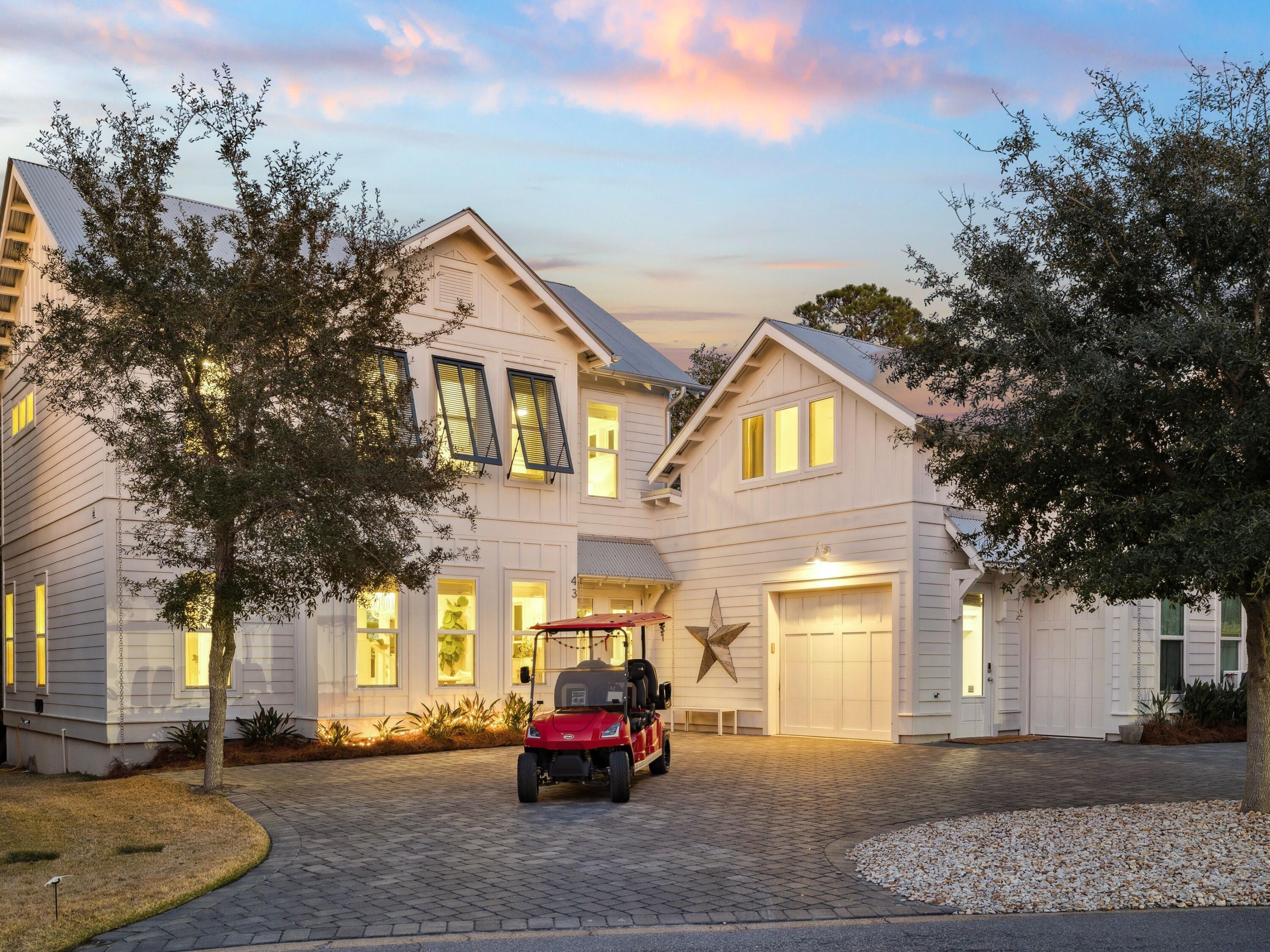 Set within the quiet heart of Seagrove Beach and bordered by a protected conservation area, 43 Suzanne Drive offers a rare balance of privacy, refinement, and effortless access to the coastal lifestyle that defines Scenic Highway 30A. Built in 2020 and thoughtfully designed for both full-time living and exceptional rental performance, the home is ideally positioned just a short walk to one of 30A's most peaceful and picturesque public beach accesses, while remaining tucked away from the high-traffic corridors of Seaside and WaterColor. Seaside's iconic town center, dining, and boutiques are a walk or golf cart ride away, creating a setting that feels both secluded and connected. The residence unfolds across beautifully curated interiors where craftsmanship and elevated finishes define each space. An open-concept living area centers around a chef's kitchen appointed with marble countertops, premium appliances, and bespoke millwork, while hand-scraped wood flooring and a wood-burning fireplace introduce warmth and timeless character. Designer lighting, including the striking Mark Moussa Tilda chandelier, enhances the home's architectural presence, complemented by custom furnishings such as the statement round living room mirror and built-in bunk accommodations.
Designed to accommodate both intimate family living and gracious entertaining, the home offers five bedrooms and four and a half baths, including two serene primary suites. A private carriage house suite just off the garage provides an ideal retreat for guests, offering both independence and connection to the main residence.
Outdoor living is equally compelling. A private pool and expansive deck create a year-round sanctuary, offering warmth and comfort during cooler months and a refreshing escape during the summer season. A screened porch extends the living space into the surrounding natural landscape, where conservation views provide a sense of calm rarely found along 30A.
With newer construction, exceptional privacy, and a location that offers seamless access to both Scenic Highway 30A and Highway 98, 43 Suzanne Drive represents a rare opportunity to own a refined coastal residence designed for both elevated living and enduring investment value in one of Seagrove Beach's most desirable settings.