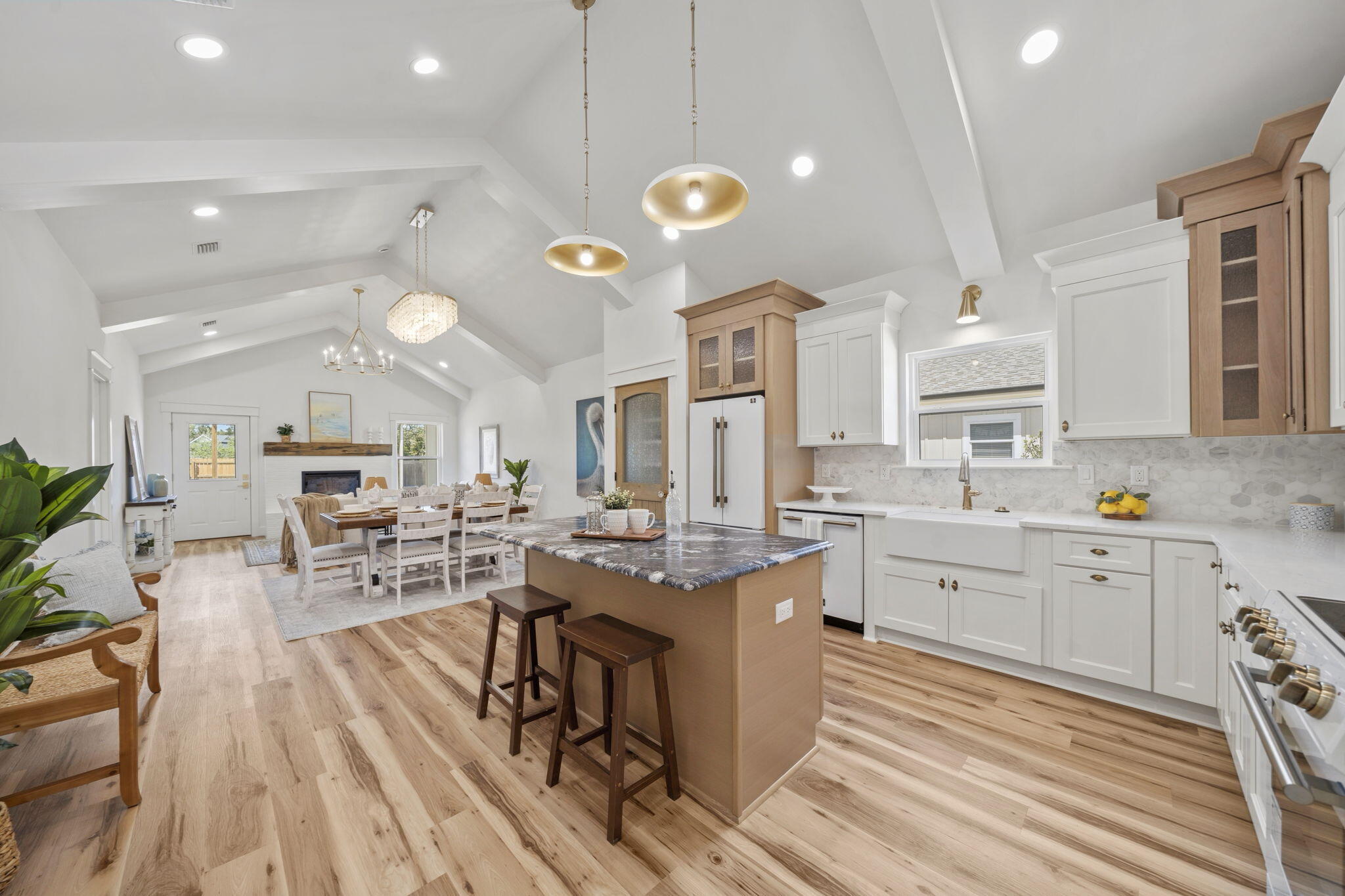 This new construction home is NOW COMPLETE and filled with upgrades including stunning custom millwork throughout! Additional land also available for sale adjacent to the property. 

No expense was spared in the construction of this gorgeous 3 bedroom, 2 bath home designed and built by Southern Belle Construction. This home is a single level with a split floorpan, vaulted ceilings throughout the great room area and offers a covered back porch that spans the width of the home. Sit on your covered back porch overlooking a spacious back yard and a 16' x 24' pole barn that is perfect for boats, RVs, cars or a shop. This home sits with an excellent proximity to a public boat ramp which will allow you to live the waterfront lifestyle we love in Florida! The pole barn offers the potential to be converted into a garage giving ultimate flexibility. This property also has a generous sized backyard and you'll love the ability to add a pool or make the pole barn your own shop or man cave!

Step inside this new construction beauty with an earthy, organic vibe. You'll be wow'd by the soaring vaulted ceilings, LVP flooring throughout and soaring ceilings. The kitchen is open and provides a spacious 6' island with seating, generous pantry, glowing quartz countertops and an earthy mix of millwork using local saw mill lumber throughout including wainscoting, beams, custom fireplace mantel and tray ceilings in the primary bedroom. Southern Belle Construction utilizes a variety of natural wood including juniper, rough cut pine, deadwood cypress and live edge cypress to create a custom gem at an incredible price point!

This well-renowned builder is known for her hand-crafted wood accents and will provide custom shaker cabinetry, upgraded appliances and a stunning fireplace making this timeless home stand apart from others! Brushed gold plumbing and designer lighting will be consistent throughout this home giving a contemporary, modern design in this new construction beauty. 

Step into the living room and warm up by the fireplace under beautiful vaulted ceilings. Open the glass door and enjoy the breezes from the back yard and an extended living area with a covered, bricked back porch that is perfect for entertaining! The primary suite stands out with tray ceilings, overlooks the back yard and offers an upgraded tray ceiling, large windows, spacious ensuite bath including a walk-in shower, soaking tub, double vanities and a generous sized walk-in closet. 

With an ideal split floor plan, the two guest bedrooms are toward the front of the home, just off the foyer. Both give spacious closets and a shared bathroom  easily accessible by the hallway. LVP flooring is found throughout the home for easy cleaning! The laundry and mudroom is near the entry way and brings light in from the front yard. 

This home sits on a deep lot and gives great curb appeal with an upgraded paver driveway, beautiful and easy landscaping. The exterior will feature a mix of tumbled magnolia bay brick and indigo blue and cream ship lap with shake Hardie and juniper wood accents.

This custom, stunning new construction home is also eligible for USDA, FHA, VA and conventional loans and the perfect opportunity to own your first home, upgrade your lifestyle or retire in style. 100% financing available for qualified Buyers! A one-year builders warranty will convey with the home. Don't miss your opportunity to own a new construction home with this many upgrades!