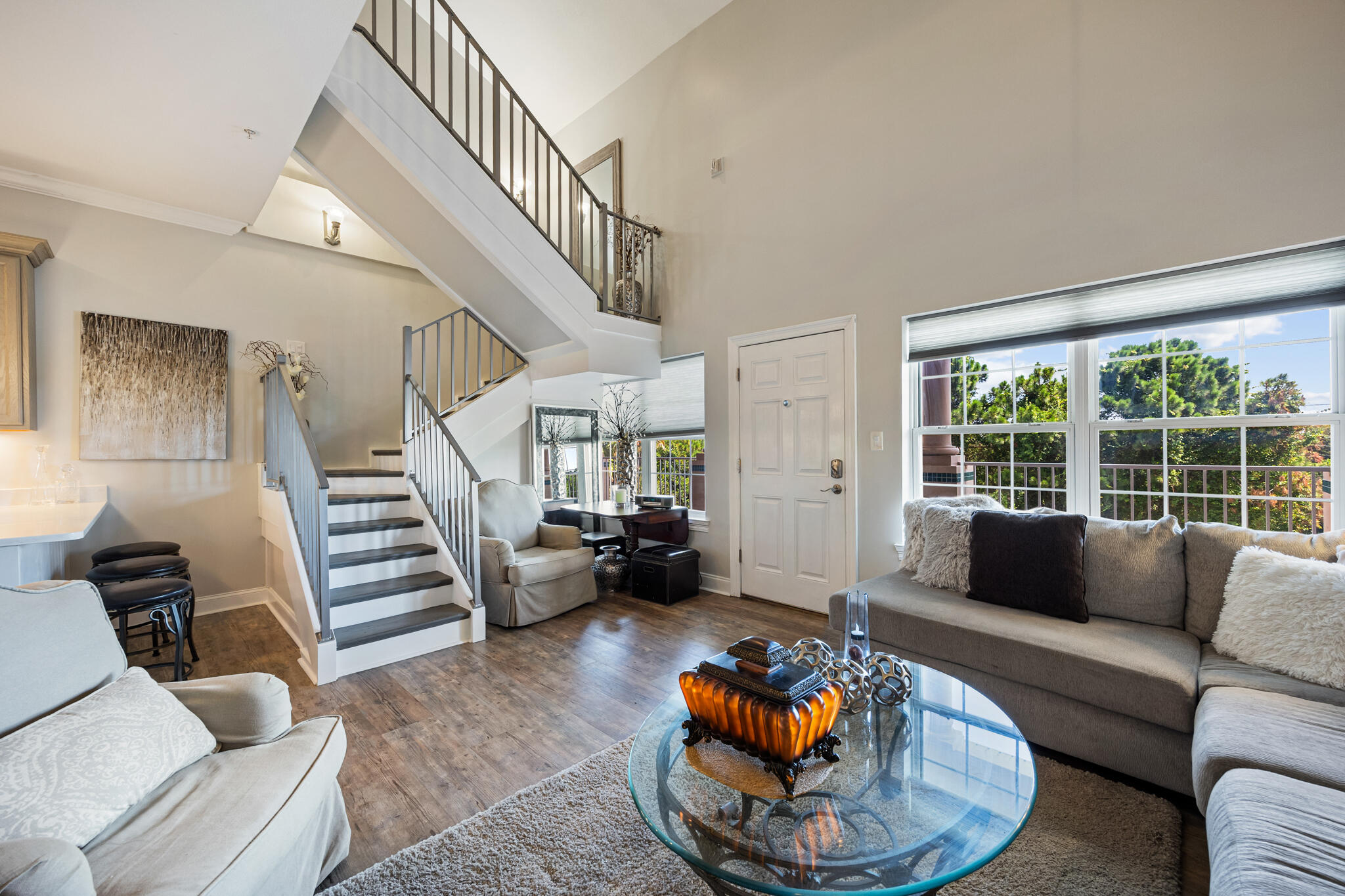 Welcome to The Plaza, a boutique 12-unit condominium located in East Destin, offering a unique blend of residential, retail, and commercial spaces in an ideal live/work setting. Perfectly positioned near the beach (just 0.6 miles), bay, shopping, dining, and everyday conveniences, this thoughtfully designed community provides a modern lifestyle with everything you need just steps away.

Unit 308 is a beautifully renovated two-bedroom residence featuring soaring ceilings, stylish finishes, and a bright, open layout. Completely transformed with a nearly $300,000 renovation, this home showcases updated flooring throughout, a fully redesigned kitchen, and beautifully upgraded bathrooms.

The stunning kitchen features new quartz countertops, updated cabinetry, stainless steel appliances, recessed lighting, crown molding, and a breakfast bar with elegant pedestal lighting. The main level also includes an elevated half bath with a custom vanity and unique sink design, perfect for entertaining.

The condo offers two primary suites, including a main-level suite and a spacious lofted suite upstairs, each with private ensuite bathrooms. The lower-level suite features a renovated bathroom with a quartz vanity, upgraded fixtures, modern lighting, and an incredible tiled walk-in shower with built-in bench and glass surround. The upstairs loft suite provides a private retreat with a custom vanity, glass sink, tiled shower, and additional nook ideal for a sitting area or office. Additional features include a converted staircase for improved accessibility, abundant storage, a full-size stacked washer and dryer, and easy third-floor interior elevator access. Enjoy peaceful nature views while making your way to the condo. The unit is being sold partially furnished and tastefully decorated, with all appliances and window treatments conveying with the sale. The Plaza is ideally located near Destin Commons, Whole Foods, Choctawhatchee Bay, Henderson Beach State Park, and some of the area's favorite coastal destinations. Crab Trap Restaurant & Beach Access is just over a half mile away, with Pompano Joe's and additional beach access points nearby. Don't miss this unique opportunity to own a beautifully renovated coastal retreat in the heart of Destin.