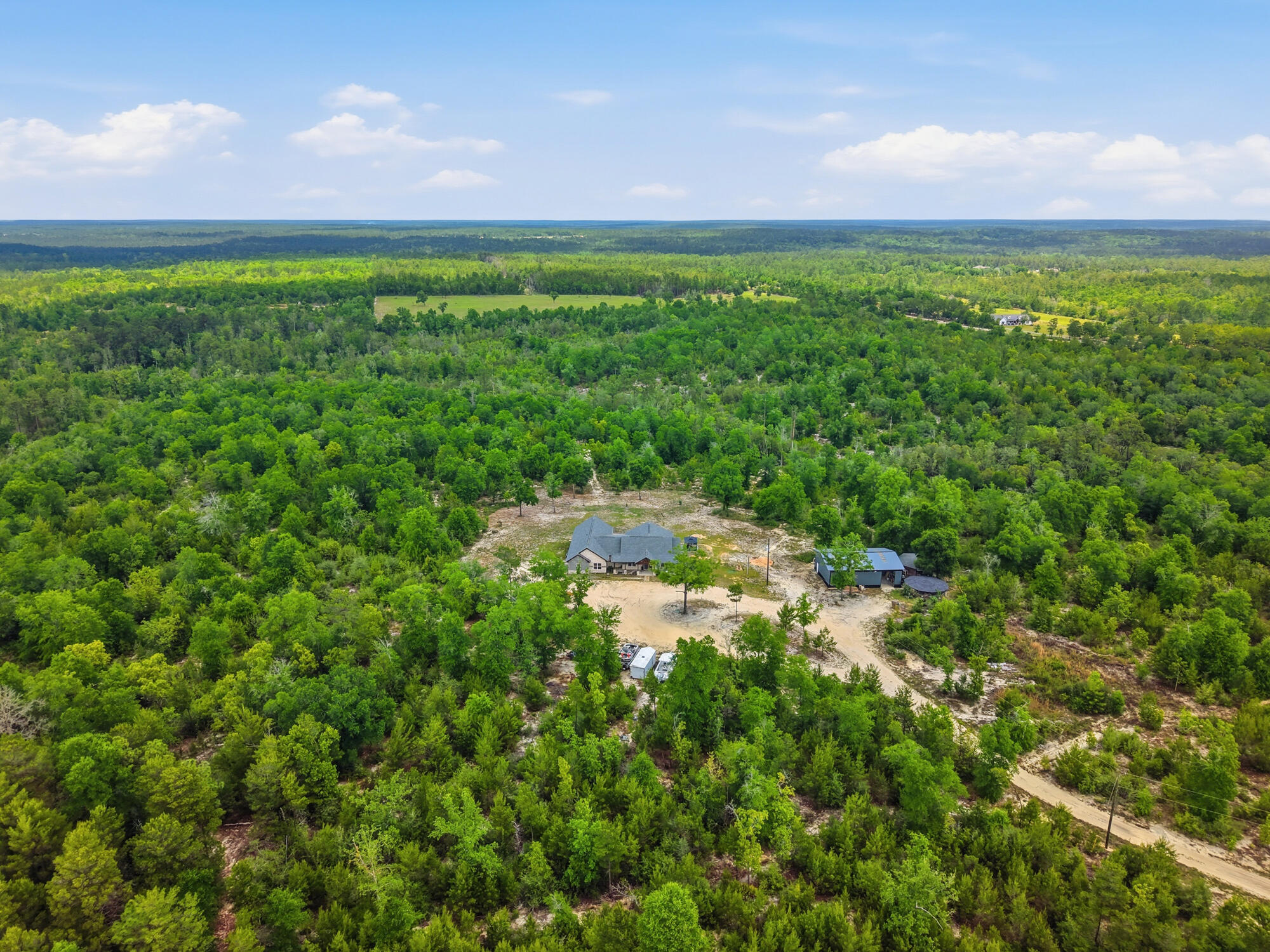 What if you didn't have to choose between the ranch lifestyle and the beach lifestyle?

Welcome to one of Northwest Florida's rarest opportunities--a custom-built home situated on 48.46 acres of private Florida countryside, complete with an established and profitable hunting ranch, all within easy reach of the Emerald Coast's world-famous beaches.

Covers Two Counties! Crestview and Mossy Head, this remarkable property offers the best of both worlds. Start your mornings watching deer roam your land, spend your afternoons enjoying the Gulf's sugar-white sand beaches, and end your evenings beneath wide-open country skies.

The custom-built residence sits on approximately 5 private acres and was designed for comfortable living while embracing the surrounding natural beauty. Down the road lies approximately 43 acres of established hunting land, carefully maintained and known for excellent deer and hog hunting opportunities. Whether you're looking for a private family retreat, recreational paradise, income-producing hunting operation, or legacy property to pass down for generations, this ranch delivers.

Properties of this size and versatility are becoming increasingly difficult to find. Here, you'll enjoy privacy, abundant wildlife, recreational opportunities, and income potential without sacrificing convenient access to shopping, dining, and the Gulf Coast lifestyle.

 This isn't just a home. It's a lifestyle. It's a hunting ranch. It's a Florida dream that most people never knew existed.

Life is short. Own the land. Enjoy the beach. Have both.
