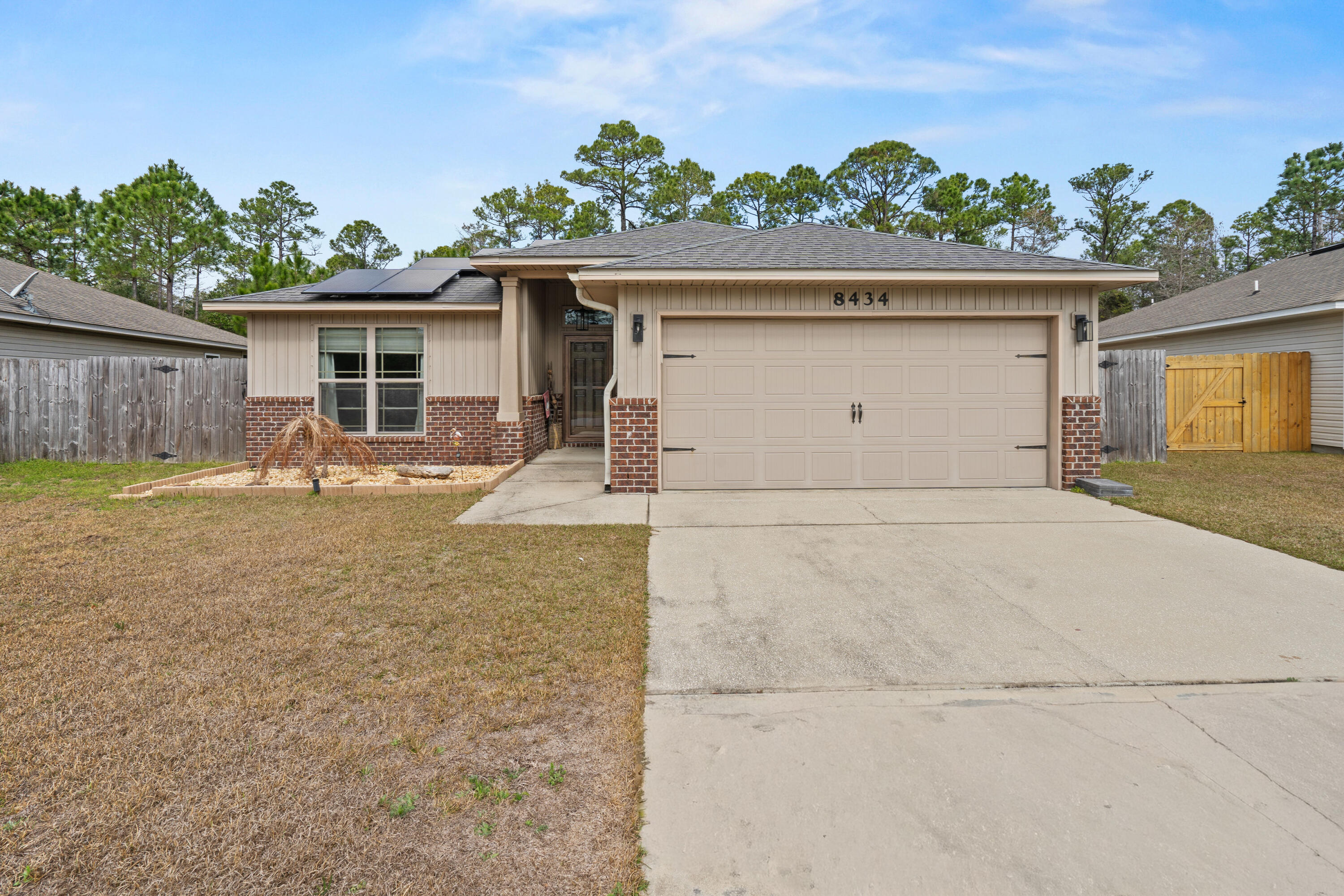 Welcome to your slice of paradise in Navarre, Florida! This beautifully maintained 3-bedroom, 2-bath home offers a thoughtfully designed living space just 2 miles from the white sandy beaches of Navarre Beach! 
Step inside to a spacious, open floor plan that's perfect for entertaining family and friends. Recent updates give this home a fresh feel, including new flooring in both guest bedrooms, fresh interior paint, new dining and kitchen light fixtures, and updated ceiling fans throughout (excluding the primary bedroom). Mounted TV outlets. 
The garage has been upgraded with newly added cabinets, storage shelving, and a workbench, offering excellent functionality and organization. The laundry room has also been enhanced with new shelving and cabinetry for additional storage. Two brand new barn-doors were added, one in the laundry room and the other in the primary suite.
Outside, enjoy updated landscaping in both the front and backyard, complete with patio blocks and stone accents -- perfect for relaxing evenings or weekend get-togethers while enjoying fresh ocean breeze and our beautiful emerald coast sunsets! 
The solar panels are paid off! Enjoy lower utility bills at no extra cost! Conveniently located to both Eglin AFB, Hurlburt Field, 7th Special Forces Group (Airborne) and Pensacola NAS.