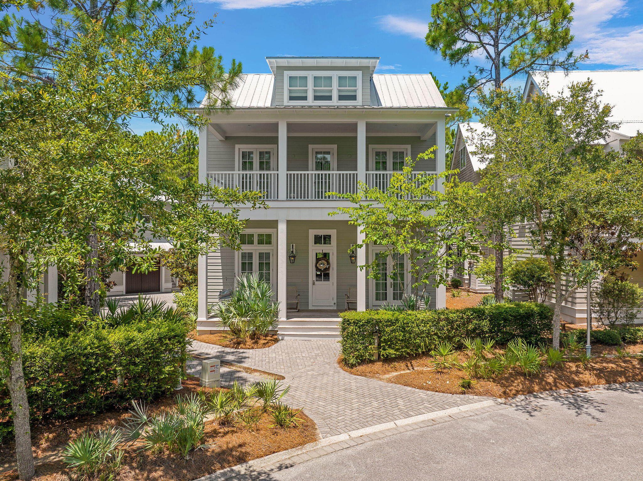 Located in Phase 2, this one family owned, never before rented home offers the privacy of a backyard preserve, a front yard facing a park area, while also being tucked nicely inside a private cove.  This home has one of the largest private family pools inside the Watercolor community and was designed by the Stackable Group and built by Cole construction.  A Peacock paver pool deck with fully fenced in back yard  expands into a summer kitchen with an outdoor fireplace.  The carriage house is fully equipped with a kitchen, full bath and extends over a full capacity two car garage.  Inside the home you will find grey washed floors, mosaic marble bathrooms, and souring ceilings. A large fireplace anchors the living and dining area. This home offers large rental projections while also providing a luxurious secluded space within the community.