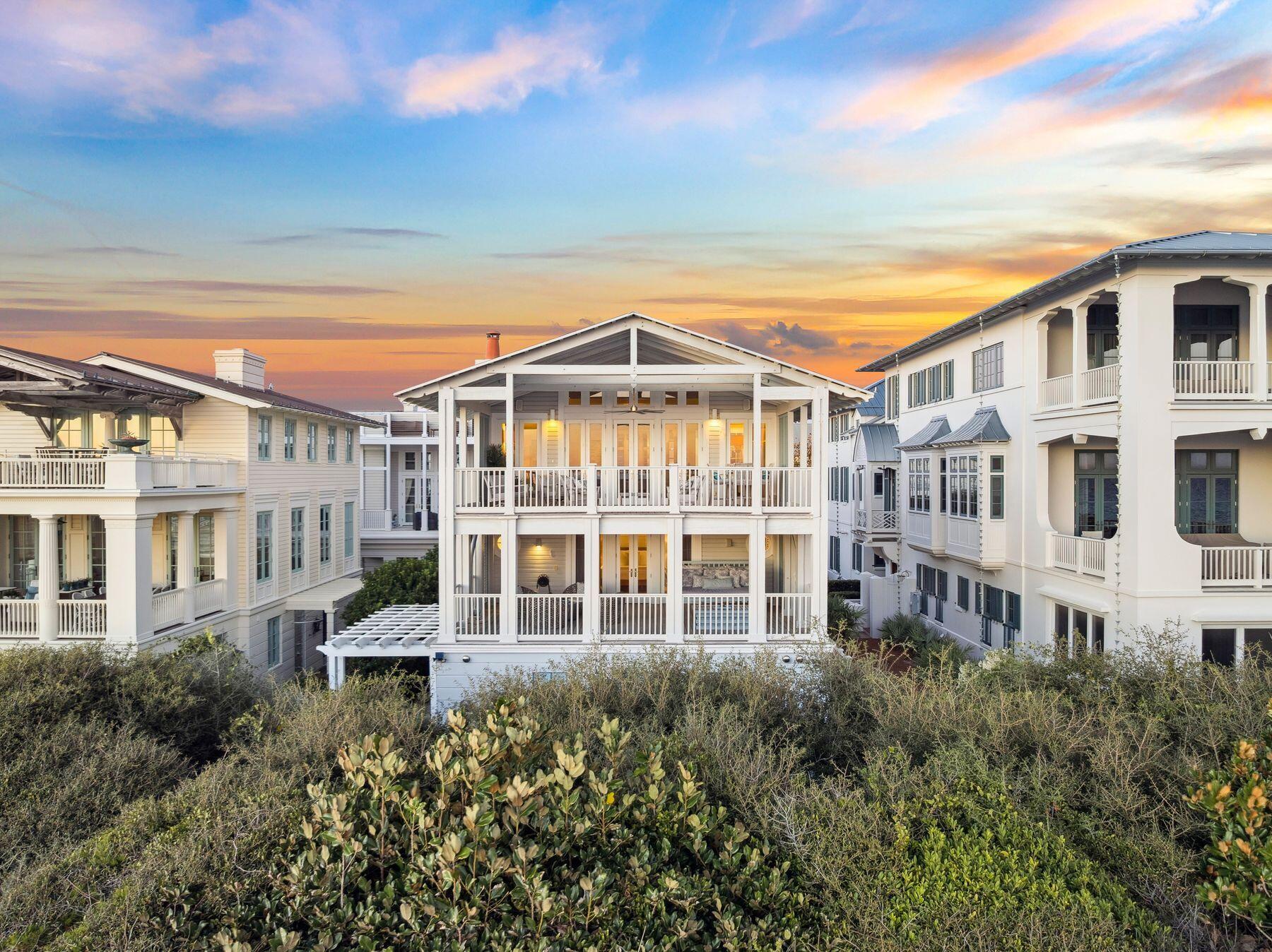 Perched just steps from the sand in the heart of Seaside, Beluga is a timeless coastal retreat where classic architecture meets easy, elegant living.  

Step through the front door and into a small, welcoming den anchored by original shiplap and rich wood floors that continue throughout the home. A private elevator, serving all three levels, sits just off the entry alongside a full laundry room.

Down the hall, two spacious king suites offer private retreats of their own. Each features a king-size bed, shiplap walls, and a full ensuite bath with a tiled shower-tub combination behind glass enclosures; the second suite adds built-in dresser drawers and a separate vanity area with polished chrome fixtures.  Both come fully furnished and ready for guests.

Farther down the hall, mirror-image bunk suites flank either side, each outfitted with two sets of twin-over-full built-in bunks and generous built-in storage. Every bunk suite has its own private bath -- one finished in marble tile with a separate shower -- and each opens conveniently to both the interior hallway
and directly to the back door, making it easy to rinse off after a day at the beach. 

An owner's storage closet completes the first floor. Take the elevator or stairs to the second floor, where a light-filled landing opens onto a cozy den with built-in storage and plenty of seating -- the ideal spot to unwind. The rest of this level belongs entirely to the primary suite, a true retreat with two separate ensuite baths. The gentleman's bath features a spa-style shower and penny-tile flooring, while the lady's bath is finished in marble with built-in storage, a dressing table, a full shower-tub combination, its own full-size washer and dryer, and floor-to-ceiling windows that flood the space with light. Step outside onto a private balcony furnished with a sleeping swing and lounge seating -- perfect for morning coffee or evening sunsets.
The third floor is the heart of the home, crowned by a soaring, light-filled ceiling designed by Scott Merrill, the same architect behind the iconic Seaside Chapel. Floor-to-ceiling windows frame panoramic Gulf views, illuminating an open living room and a dining area that comfortably seats eight with room to spare. 
The kitchen is outfitted with Viking appliances including a six-burner gas range, marble countertops, a farmhouse sink, a dishwasher, and generous counter space, with a pass-through window connecting it to the living area so the whole floor feels open and connected. A powder bath sits just off the kitchen. north-facing windows look toward Seaside's town center, and the elevator reaches all the way here, opening directly into the kitchen.
Beyond the living area, step out onto Beluga's show-stopping entertaining porch. Finished with the same signature ceiling detail as the living space inside, this expansive outdoor room comfortably seats a crowd and includes space for outdoor dining, all beneath sweeping Gulf views -- the perfect stage for sunset gatherings and long, easy evenings by the water.
Fully furnished and thoughtfully laid out across three levels, Beluga sleeps up to eighteen guests across five bedrooms and five and a half baths in roughly 3,500 square feet -- offering the rare combination of architectural character, everyday comfort, and true Gulf-front living.