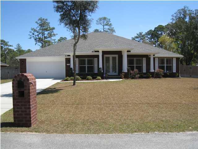 Welcome to your private resort-style escape in the heart of Navarre! This stunning pool home offers incredible space, great bones, and a lifestyle built for entertaining, relaxing, and making memories. Step through the oversized covered front porch and 8' double glass doors into a bright, open layout featuring 10' ceilings, recessed lighting, detailed tile work, and a spa-inspired primary bath with a beautifully tiled walk-in shower. The chef's kitchen sits at the center of the home with a large island breakfast bar, downdraft range, and double ovens, flowing seamlessly into the dining and living areas for easy entertaining. Out back, enjoy your own private oasis with a heated saltwater gunite pool and spillover spa, perfect for year-round use. One of only two homes with this unique floor plan, offering rare design and character. Home is being sold AS IS and does need a little updating, giving a great opportunity to customize and build equity.