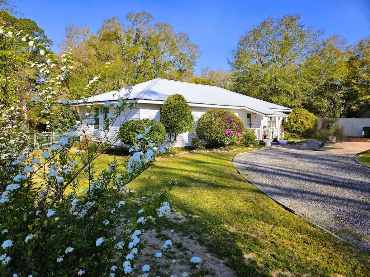 Rare opportunity in the historic district of DeFuniak Springs! Situated on an exceptional 1.42-acre parcel near the iconic Lake DeFuniak area, this charming 1945 home offers a unique blend of historic character, privacy, and space seldom found within downtown residential settings. Surrounded by mature trees and historic homes, the property provides endless possibilities for gardens, outdoor living, workshop space, guest quarters, or future expansion. Enjoy the charm of tree-lined streets, walkability to downtown amenities, and the rarity of owning one of the largest residential parcels in the area, with occasional deer visits . A truly unique historic district property with tremendous upside and long-term appeal. Enjoy a walkable lifestyle to downtown DeFuniak Springs, with its local shops, dining, and community events centered around the lake. Additionally, this location offers convenient access to the white sand beaches and world-class amenities of South Walton and Scenic Highway 30A, making it an ideal balance between small-town charm and coastal living.

This is a rare chance to secure a large homesite in a highly desirable historic setting--perfect for homeowners, investors, or those seeking a long-term land play in a growing market.