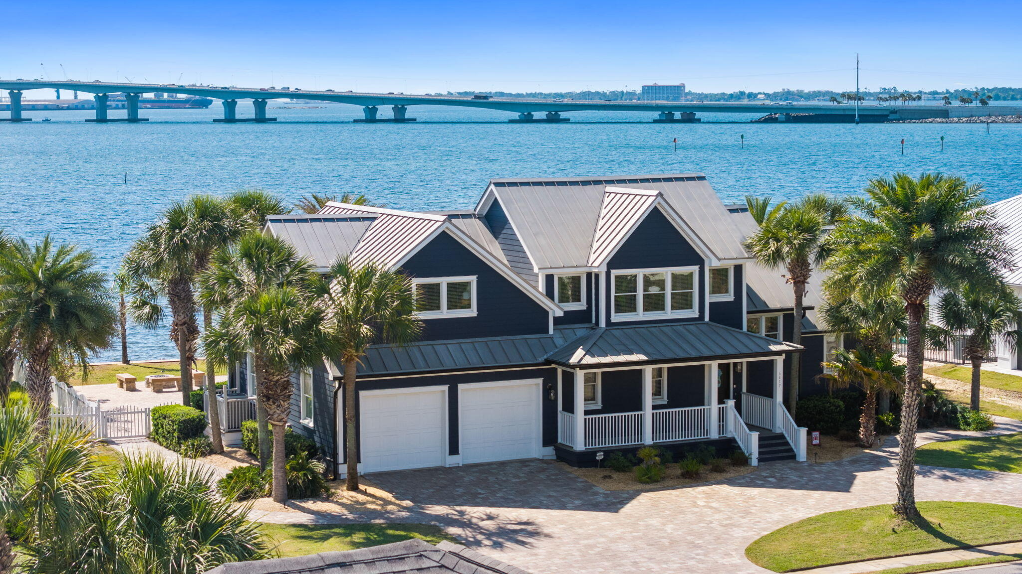 Pre-appraised and priced to sell, this bayfront 4BR/3.5BA home offers luxury, comfort, and move-in ready convenience. Rich pine hardwood floors, vaulted ceilings, open floor plan, and upstairs balcony create a grand yet inviting feel. Renovated chef's kitchen features Viking 6-burner stove with griddle, Viking microwave, and Sub-Zero refrigerator. Recent updates include exterior paint, gutters, pool heater, resealed pavers, kitchen remodel, custom built-ins, rescreened porch, and new doors. Outside enjoy an oversized pool, screened porch, firepit area, seawall lighting, and sweeping bay views with the Hathaway Bridge as your backdrop. Exceptional waterfront living awaits.