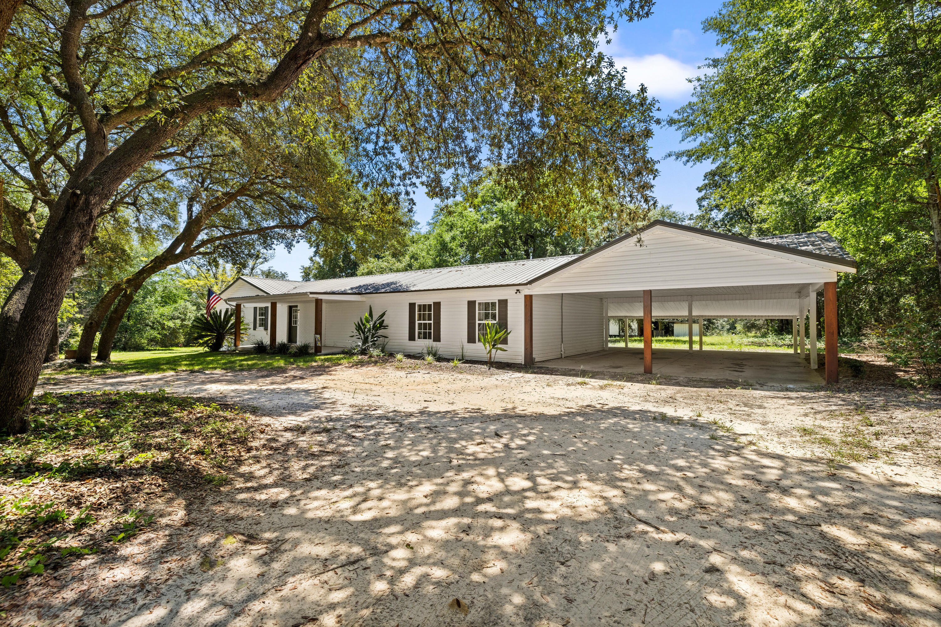 Charming farmhouse living on 4.05 acres! This 4BR/2BA home overs over 2,400 SF of space, including a sun-filled Florida room. Inside, the kitchen and baths have been tastefully updated while maintaining the warm country character that makes this home special.

Recent improvements provide peace of mind: HVAC, septic, water heater, and metal roof.

The acreage is full of possibilities-grapevines, walnut trees, and blueberry bushes already thrive here, while a mix of open land and shaded woods gives plenty of room to garden, raise animals, or simply relax. An outbuilding with covered space offers storage or hobby use and conveys as-is.