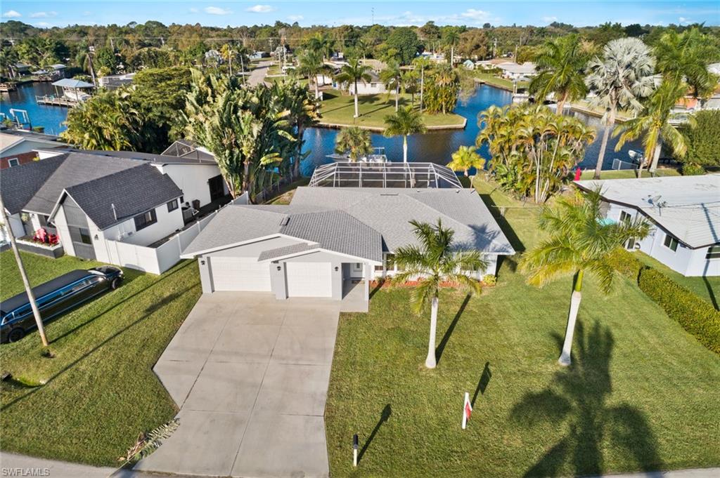 A boaters dream! Spectacular water views in this 3 bedroom 2 1/2 bath pool home with intersecting canal views located on a quiet cul-de-sac. Newly renovated and meticulously maintained with deep water access just 10 minutes to the river. New roof and water heater in 2016. New kitchen featuring soft close cabinetry, stainless steel appliances and granite counter tops. All the main living areas boast large diagonal tile flooring and brand new carpeting in the bedrooms. Master bedroom has private bath and walk-in closet. In residence laundry with "cabana bath" just three steps from the pool. Attached 2 1/2 car garage with 9' ceilings and 8' garage doors to accommodate all your "bigger toys" with space for a workshop. There's a 100 amp breaker panel to power all your tools and equipment, imagine the "man cave" or "she shed" potential! The driveway will accommodate 6 vehicles. Gorgeous 14' x 28' in-ground pool with 7 1/2' deep end and totally screened. Pool is heated via heat pump and solar cover. Aluminum boat lift with 10,000 lb capacity along 40' of dock, connected to 61' of seawall that is in perfect condition. The home is wired for cable and Ethernet throughout.