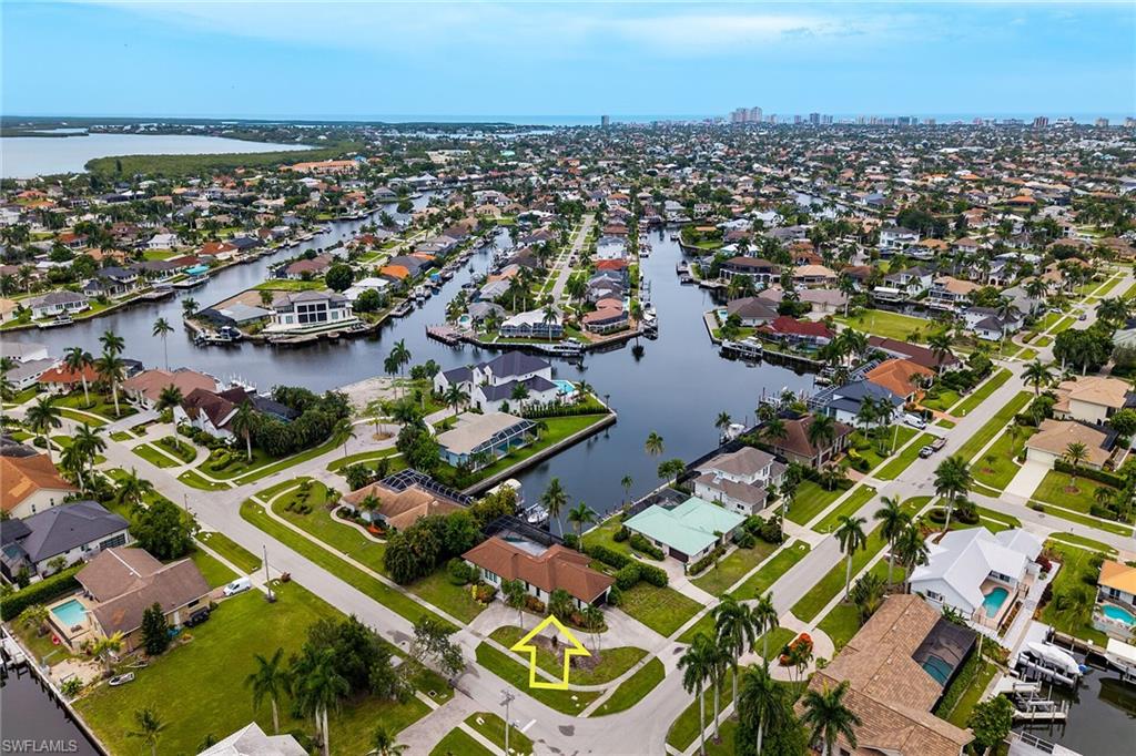 Waterfront living reaches a new level with this beautifully reimagined residence, ideally positioned on one of Marco Island's most desirable direct-access canals. Offering fast, bridge-free Gulf access, this exceptional property is a true paradise for boaters, where spontaneous sunset cruises, fishing excursions, and days on the water begin right from your private dock. With a newer seawall, upgraded dock, and the Yamaha boat included in the sale, your Southwest Florida boating lifestyle starts the moment you receive the keys. Perfectly oriented with coveted southern exposure, this 3 Bedroom / 3 Bathroom home captures abundant sunshine throughout the day while showcasing breathtaking long-water canal views that create an ever-changing backdrop of sparkling blue water. Inside, warm walnut wood flooring flows throughout the residence, complemented by soaring volume ceilings, recessed lighting, and impact-resistant windows and doors that blend timeless elegance with peace of mind. Designed for effortless coastal living, the open-concept floor plan seamlessly connects the living spaces to the expansive screened lanai, where panoramic water views become the focal point for relaxing mornings, afternoon entertaining, and unforgettable evenings overlooking the canal. The thoughtfully designed kitchen is equipped with premium Bosch stainless steel appliances, including a French-door refrigerator with icemaker, range, microwave, and dishwasher, while the adjoining breakfast area opens directly to the lanai--perfect for enjoying coffee with the sunrise or casual waterfront dining. The spacious primary suite serves as a peaceful retreat, featuring private lanai access, a custom walk-in closet, and a beautifully appointed bath with dual vanities, full-width mirrors, built-in cabinetry, and a walk-in shower. A generous guest suite offers its own walk-in closet and en-suite bath, while the third bedroom provides flexibility for guests, a home office, or hobby space. Outdoor living is equally inviting, with a newer tile roof and upgraded panoramic screened lanai complete with tile flooring, ceiling fan, and convenient pool bath, creating an ideal setting for entertaining after a day on the water. A well-equipped laundry room with front-load washer and dryer, built-in cabinetry, and overhead storage adds everyday convenience. Whether you're an avid boater seeking immediate Gulf access or simply dreaming of peaceful waterfront living with spectacular long-water views, this exceptional residence delivers the very best of the Marco Island lifestyle where every day begins and ends on the water.