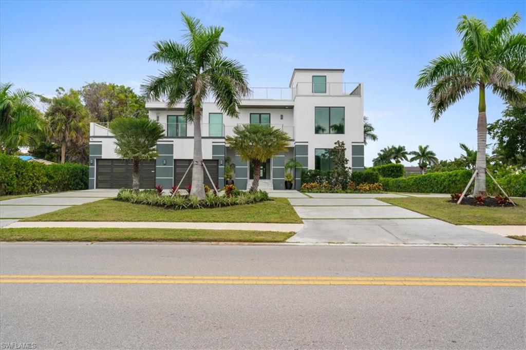 Located across from the water, enjoy waterfront views from entertainers deck! Built in 2023, this exceptional 4-bedroom, 6-bath residence offers the rare opportunity to own a nearly new luxury home in one of Naples’ most sought-after locations—without the premium pricing of waterfront properties. Home features 4 bedrooms and 6 bathrooms with thoughtfully designed living and entertaining spaces throughout. Features include two laundry rooms, a 3-car air-conditioned garage, second-floor wet bar, and multiple indoor-outdoor living areas. The chef’s kitchen is equipped with top-tier appliances, custom cabinetry, and generous workspace, opening seamlessly to the main living areas with soaring ceilings and refined finishes. A private elevator services all levels, including a fully built-out rooftop retreat featuring an outdoor summer kitchen, cabana bath, and water views—ideal for elevated entertaining. Outdoor amenities include a resort-style pool and spa, covered entertaining areas, and lush landscaping. Built with concrete block construction, impact-resistant windows and doors, and premium materials throughout. Ideally located minutes from the Gulf beaches, Venetian Village, and Fifth Avenue South, this move-in-ready home offers luxury living in one of Naples’ most sought-after neighborhood.  With new construction comes peace of mind: modern systems, current building standards, and no renovation delays. Property Owner would be eligible to obtain membership with the Park Shore Association which affords access to a private beach park, membership is voluntary.