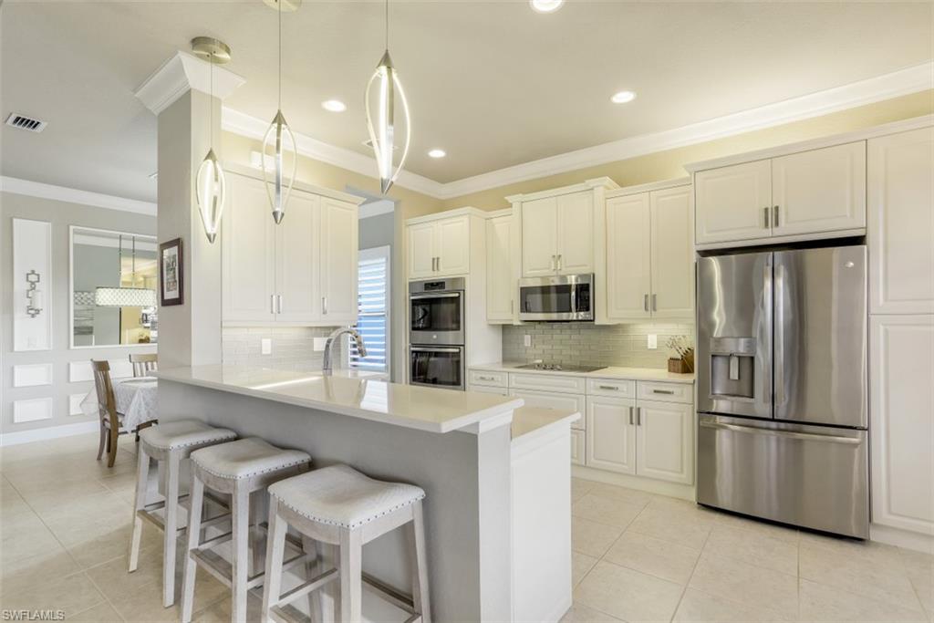 Welcome home to this beautifully appointed home in Marina Bay! The Granada by GL Homes is one of the most popular floor plans available in the community. This open and elegant layout boasts 3 spacious bedrooms, large office space, 3 full bathrooms and 3 car garage! The gourmet kitchen features stainless steel appliances, quartz countertops, wall to wall custom bright white cabinetry and a breakfast bar that opens to the great room. Luxury finishes/upgrades include crown molding throughout, LED lighting, plantation shutters, neutral tile flooring in the main areas, & epoxy floors in the garage. The rear lanai offers abundant covered/uncovered space, a pool & spa & a tranquil view of one of Marina Bay's sparkling lakes. Marina Bay has full resort amenities with pools, tennis, pickleball, basketball (indoor & outdoor), fitness center, social activities, playground, waterslides & splash pad. Low HOA fees include a gated entrance (with live security), lawn & landscape maintenance, and much more.