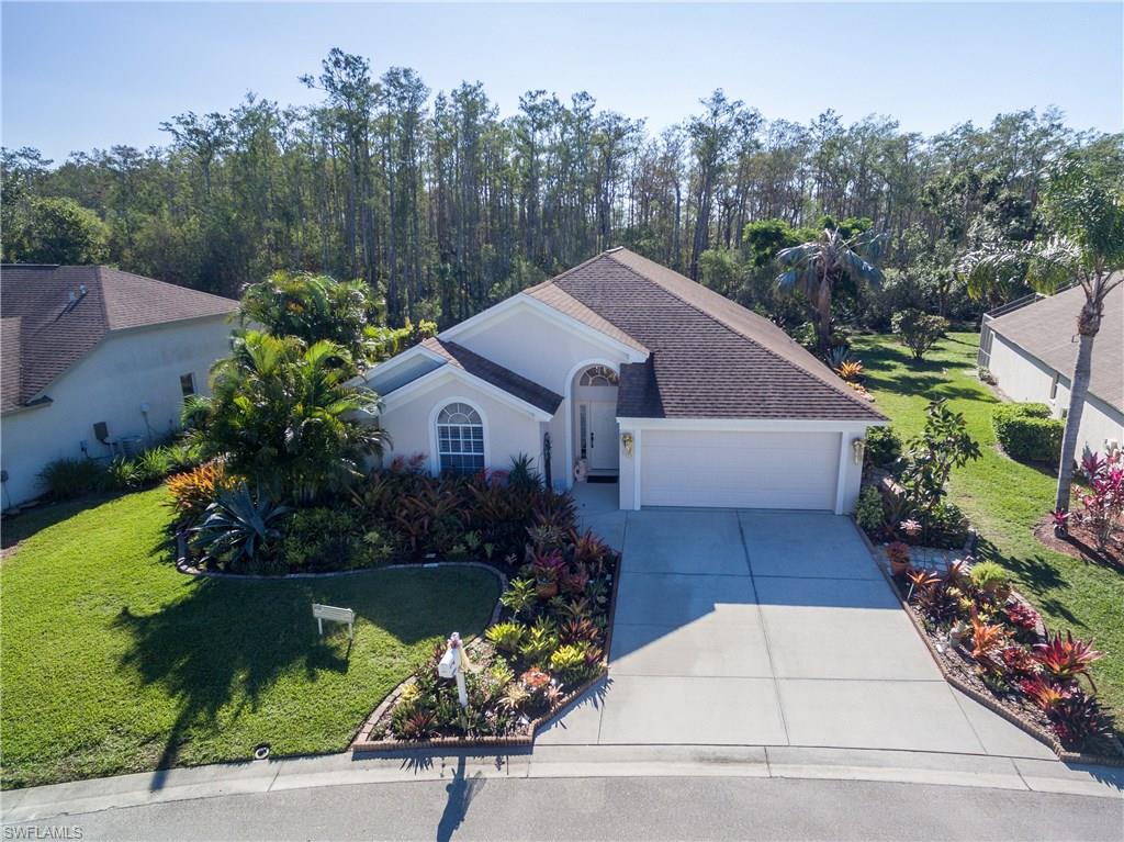 Location! Location! Location!  This 4 Bedroom, 2 Bathroom beauty with a 2 Car Garage, is built concrete strong for lower insurance rates and has LOW MONTHLY FEES OF $72.00!!  You will love your new luxury lifestyle with this serene Waterfront, Sunny and Cheerful Home with a stunning lush landscape to take in the Florida sunshine.  This welcoming oasis is a gardener and nature lovers paradise with amazing colorful bromeliads and flowering plants and trees to attract butterflies.  On your private tour you will be surprised by the size of this large Creekside yard with protected and private views of the “no-build” woodlands.  This beauty offers: An Open Floor Plan, Vaulted and Soaring 14’ Ceilings, 16” Diagonal Tile, Stainless Appliances, Hardwood Floors, Storage and more!  If you enjoy outdoor living, this is the perfect primary residence or 2nd home with an extended Lanai for grilling and entertaining.  Popular Coconut Pointe and Hertz HQ is across the street, and Miromar Outlets and Gulf Coast Town Center are minutes away.  The nearby famous white sand beaches await you!   Enjoy our 25 photos and virtual tour and see what makes this home so special.  Call today!