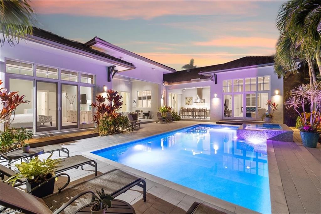 Available for immediate occupancy.  No interior flooding damage from Hurricane Ian. Highly desirable Moorings single-story residence is move-in ready and offers an unmatched lifestyle opportunity within walking distance to Naples' famous sugar sand beaches. Designed by Falconer Jones and built by Knauf-Koening, this luxurious great room floor plan features coffered ceilings, Legno Bastone oak floors, custom built-ins, a well-appointed kitchen with Sub Zero & Wolf appliances, Ruffino cabinetry, a butler’s pantry and quartz counters. Multiple pocketing glass sliding doors lead out to two spacious covered lanais and a lushly landscaped backyard complete with a cabana room, summer kitchen, electric screens and shutters, and a heated saltwater pool & spa. The secluded primary retreat, with an expansive walk-in closet, features a custom shower with multiple shower heads, separate soaking tub, and dual vanities. Four additional en-suite bedrooms provide comfortable and private space for family and friends. Perfect for entertaining, this home is eligible for the Moorings private beach access.