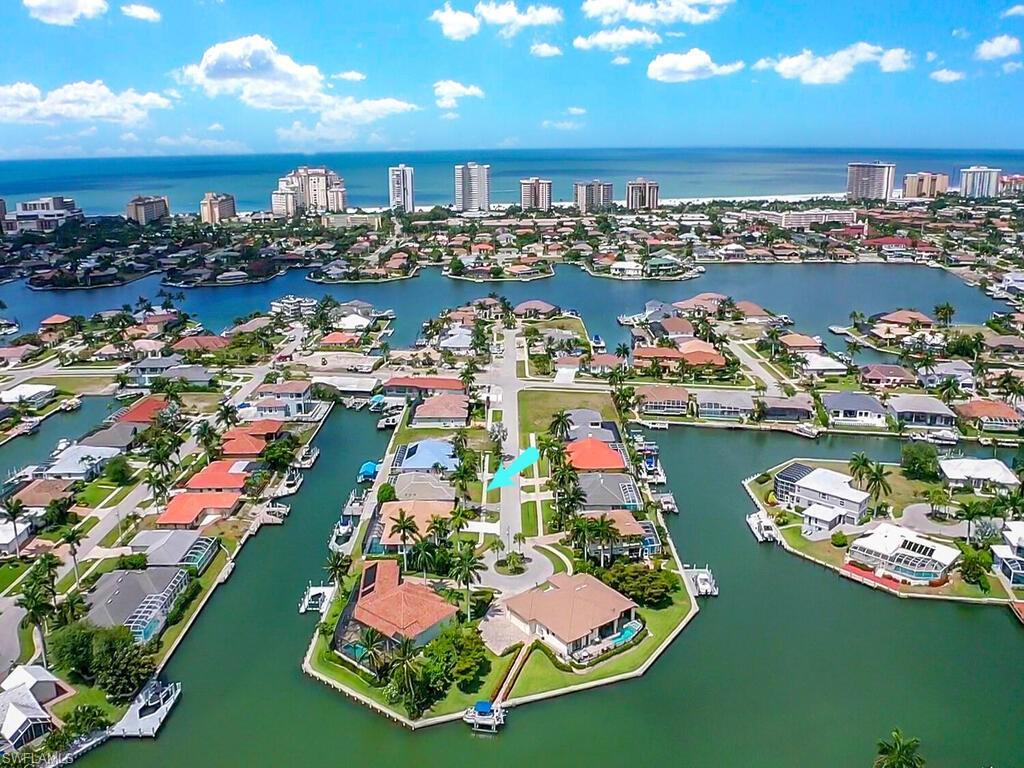 When boating and beach are your dreams!  You'll want to see this one first!  Located less than a mile from the Marco Island Residents' Beach on the world renowned sandy shores of the Gulf of Mexico and on a canal with a boat dock and boat lift.  With a replaced seawall and Gulf access, this home features a great room floorplan. under roof lanai and screened lap pool/enclosure.  Southern exposure, tile and carpet floors, two primary bedroom walk-in closets, high ceiling in the living area and a new roof in 2018 - compare this one and begin planning your next home and lifestyle experience!  Minutes to restaurants, entertainment, outdoor recreational activities and sports, shopping and more!  Within walking or biking distance to Marco Walk Plaza, featuring many fabulous dining and shopping establishments, as well Marco Movies theater. Enjoy fishing in the 10,000 Islands, water skiing, jet skiing, kayaking, canoeing and best of what Marco Island living has to offer!  Or simply relax on the screened lanai, dip in the pool, barbecue and cool off in the pool!  You deserve to take advantage of all the benefits of Southwest Florida living!