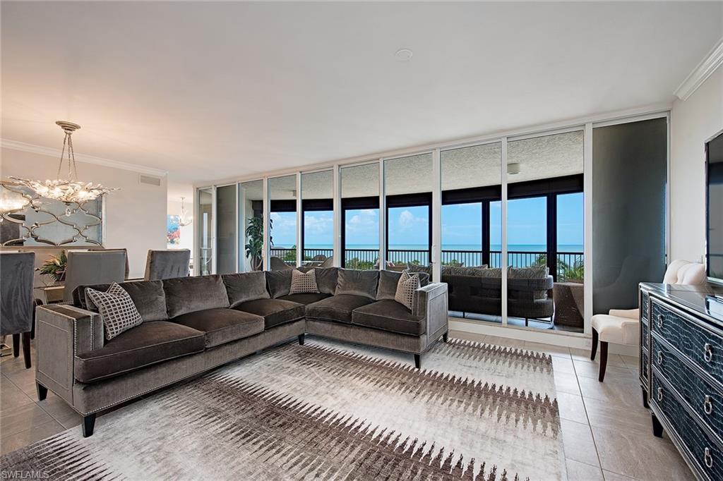 Gorgeous Gulf and sunset views! Enjoy hearing the waves roll onto the sand from the spacious lanai of this tastefully furnished residence directly on the beach in the private gated community of Bay Colony in Pelican Bay. Featuring panoramic views of the Gulf of Mexico through floor-to-ceiling sliding glass this highly sought after floor plan welcomes you into an elegant entry foyer and spacious living area boasting nine-foot ceilings, separate dining area, and eat in kitchen with tons of natural light. There is plenty of room for entertaining family and guests with three full bedrooms all with ensuite baths. The Remington amenities include a gorgeous designer renovated lobby with 24-hour manned front desk, two guest suites, fitness center, social room, and a resort-style pool. Bay Colony residents enjoy the use of their own private newly renovated beach club and restaurant, Bay Colony tennis club, as well as the use of the amenities and additional two private beach clubs of Pelican Bay. Private golf memberships are available separately.