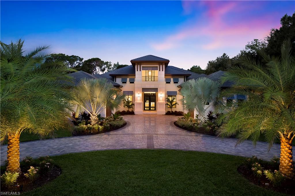 Stock Signature Home offers move-in-ready fully furnished model home in beautiful Pine Ridge. Shelia Corasaniti has created a serene coastal retreat finished in relaxed and soothing colors. Inspiration taken from a chinoiserie printed fabric that depicts the colors and tones represented throughout the home in a color palette of soft sandy taupes with accents of powdery sky blues and tonal creams. Featuring weathered Oak wood flooring throughout the home. Outdoor living space is painted a soft off-white to complement a stainless gas fireplace fashioned from light taupe chiseled stone. In addition to the beautifully appointed fireplace, a conversation area sits just off the great room and the master bedroom sitting area. At the opposite end of the lanai, an outdoor kitchen features Naturecast shaker style cabinetry, granite countertops and backsplash, Alfresco gas grill with stainless hood and U-line outdoor under counter refrigerator and electric roll down screens. Enjoy the oversized luxury designed auto-salt generating swimming pool with LED lights, sundeck with Southern exposure. Retreat to the wood burning fireplace with long lake views. Room for sport court and children to play
