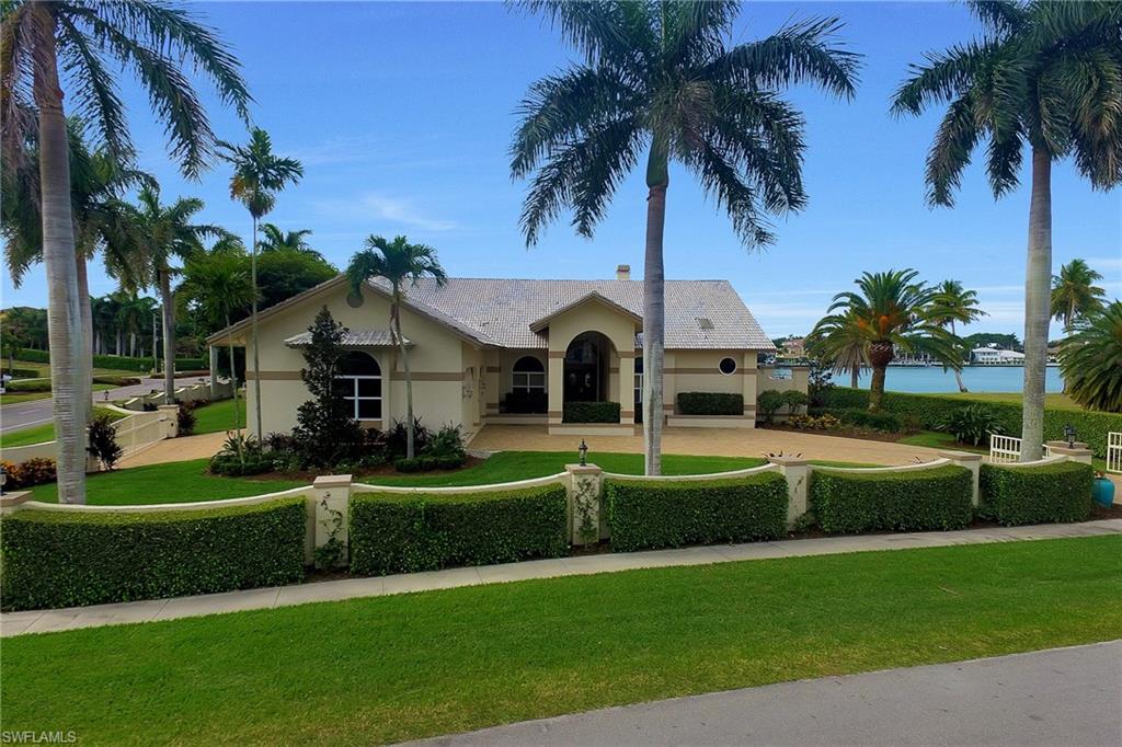 Prestigious Gated Executive Home in heart of Marco Island's Estate Area boasts Sensational Water Views of Roberts Bay & Marco's Sunsets with A SW exposure! Oversized .56 Acre Pinch Lot offers this 3Bed/3.5Ba split plan Residence with Splendid 4900SF of Screened/Pavered Lanai featuring a Free-Form Pool,Spa,Fountain,Outdoor Kitchen & True Pool Bath with shower. This Estate Home offers both Formal Living & Casual Family Rooms, OPEN Eat-in Granite Island Kitchen with Custom Poggenpohl Wood Cabinetry & High-End Sub Zero/ Thermador SS Appliances, Dining Room, Private Master Wing with office of Custom Granite/Wood Built-ins, Sitting Area, His/Hers Vanities & Walk-In Closets, Whirlpool Tub, New Walk-In Shower, Skylight & Private Patio Access as well as Pool/Lanai Access. Saturnia Marble Flooring, Fabulous Guest Wing with 2 Gracious Guest Rooms & stunning Guest Bath, Faux Painting throughout, Volume Ceilings, Fireplace, Magnificent Water Vistas without the maintenance of a seawall, 3.5 Car Drive-Thru Garage with automatic doors on each end, newly pavered circular driveway, Porte-Cochere, Portico, Tropical Landscaping & 2 Gated Entries! This truly is a PREMIUM Estate Property of Distinction!