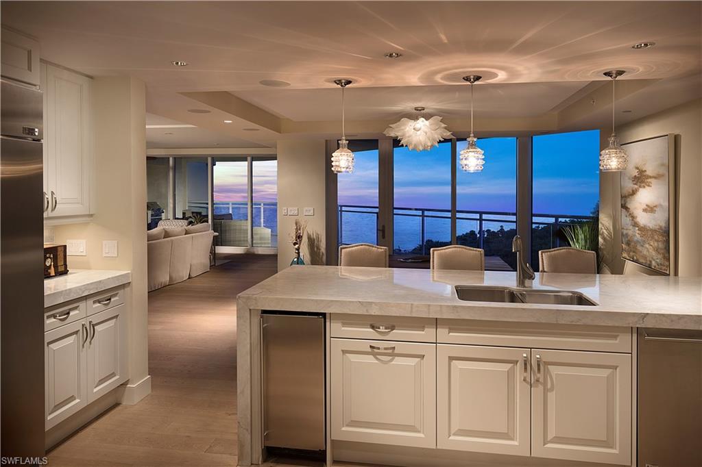 SWEEPING VIEWS OF THE GULF AND PRESERVE.  SEE ALL THE WAY TO CAPTIVA FROM THE AWARD WINNING MORAYA BAY! A STAYCATION WITHIN A 5 STAR RESORT.  FULL BEACH AND POOL SIDE DINING! This gorgeous furnished unit offers an elegant beach vibe decor with wood floors thru out, crown molding & custom finishes. With over 4500 square feet of living space this 3 bdrm + den  includes 2 master suites. Large open terrace has over 720 sqft that includes summer kitchen & glass railing. Master bedroom, kitchen, living & dining area overlook the turquoise waters of the Gulf and beach. Private elevator drops you in the paneled rotunda foyer that flows to the open floor plan. Incredible designer kitchen with a 3 inch thick Marble Calcutta creama countertop with waterfall edge and marble backsplash. Includes 6 burner gas cooktop, 2 wall ovens, warming drawer. Full butlers pantry with additional dishwasher and full size refrigerator & wine frig. 2 master en-suites, main master bath with dual vanities, natural stone flooring. Walk in closet, including sitting room. Moraya Bay includes concierge service, private beach club, large state of the art fitness center full manned security.