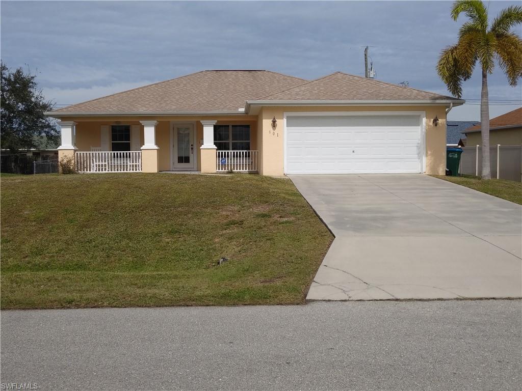 HERE IS A MOVE-IN READY HOME!  Are you tired of taking care of a pool, well you don't have to at this house!
Welcome to this "just right" 3-bedroom, 2-bath home with LARGE fenced-in back yard to enjoy from your lanai or participate with Bar-B-Q pit and roast marshmallows, horse shoes, corn toss or badmitton.  More enjoyment can be found on the railed front porch to sit and watch your friends and neighbors while they are out and about.  This home has been freshly painted outside within the last six months, and the interior of the home was completely painted a soft neutral creamy color in January 2020.  The tile and grout floors throughout the house were also polished in January 2020.  This home is ready for you to move right in and is available for a quick closing.   The living room, dining, and kitchen make a great room with vaulted ceilings.  The bedrooms are split with the master bedroom on the east side of the house and the two guest bedrooms are on the west side of the house.
