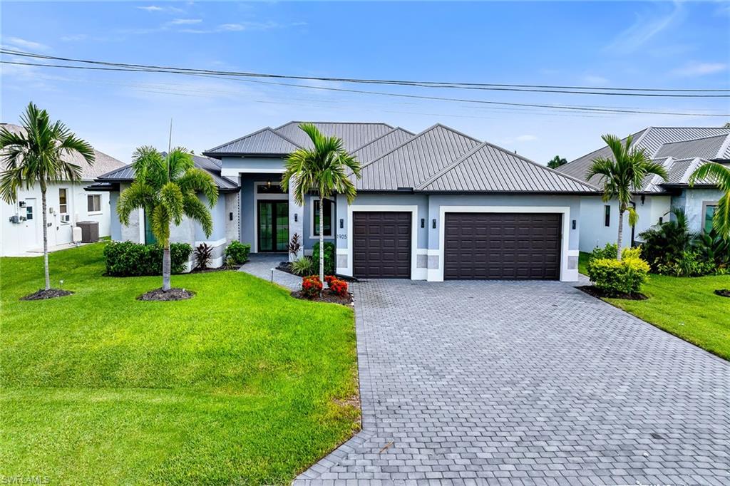 Experience the best of Southwest Florida living in this spacious modern canal-front residence, thoughtfully designed with five bedrooms, five bathrooms, and a three-car garage. Blending contemporary elegance with exceptional indoor-outdoor living, this home offers an open, light-filled floor plan that captures beautiful water views while providing the comfort and functionality today's buyers are looking for.Inside, tile flooring flows throughout the home, complemented by tray ceilings and an abundance of natural light. The expansive living and dining areas create an inviting space for entertaining, featuring a stylish dry bar with a wine cooler, an electric fireplace, and dramatic corner sliding glass doors that create a seamless transition to the lanai while maximizing the waterfront views. The gourmet kitchen is equally impressive, offering a large island with a waterfall countertop and seating, a pantry, and stainless steel appliances including a dishwasher, microwave, refrigerator with freezer and icemaker, wall oven, and electric cooktop, making meal preparation both effortless and enjoyable.The private primary suite is a relaxing retreat with direct access to the lanai, plentiful natural light, a ceiling fan, and dual walk-in closets with custom built-ins. The spa-inspired primary bath showcases dual vanities, an expansive walk-in shower with a soaking tub inside, and an enclosed water closet for added privacy. Guests will appreciate the well-appointed accommodations. The first guest suite features sliding glass doors to the lanai, a ceiling fan, a walk-in closet with custom built-ins, and an ensuite bath with a glass walk-in shower. Two additional guest bedrooms offer generous closet space and share a beautifully finished bathroom with a glass walk-in shower. A fourth guest bedroom includes a closet, an ensuite bath with a glass walk-in shower, and the flexibility to serve as a den, office, or media room. An additional full bathroom is conveniently located off the hallway with direct access to the lanai, perfect for pool days. The laundry room comes complete with a washer and dryer.Designed to embrace Florida's outdoor lifestyle, the screened lanai features a sparkling pool with a sundeck, a covered seating and dining area accented by a warm wood ceiling and ceiling fans, an outdoor kitchen, and a convenient pool shower. Set along a canal, this exceptional property offers the perfect backdrop for relaxing, entertaining, and enjoying waterfront living year-round.