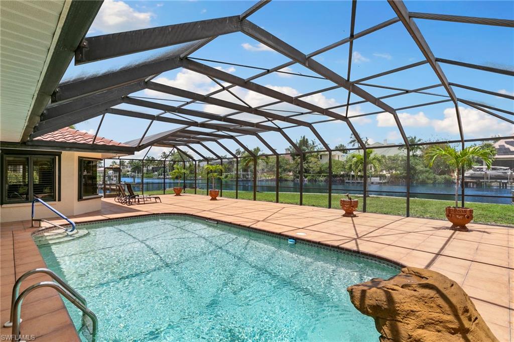 Set along on approximately 200 feet of sought-after Imperial River this 4 bedroom, 2.5 bath waterfront estate on an oversized corner lot of nearly an acre has been privately cherished for over four decades and is now being offered for the very first time. The care put into this home is evident the moment you arrive.

Set along approximately 200 feet of sought-after Imperial River frontage plus 150 feet of canal frontage, this rare property offers a waterfront setting you simply cannot manufacture. Enjoy a private wooden boat dock, heated pool, and wide open water views that greet you every morning. With Gulf access and no bridge restrictions, you’re minutes from Barefoot Beach, Bonita Beach, Lovers Key, and the barrier islands beyond.

Inside, you’ll find generous living spaces, vaulted ceilings, a fireplace, and a thoughtful split-bedroom layout. All wrapped in impact-resistant windows and a screened lanai built for the Southwest Florida lifestyle. Nearly an acre on a dead-end corner lot, no HOA, no restrictions — the kind of freedom, frontage, and space that simply doesn’t come available anymore in this community.