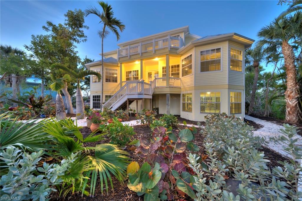 Welcome to your private island retreat on the serene and highly sought-after Dinkins Bayou, where breathtaking wide water views meet direct boating access to both the Gulf and Bay. This stunning, elevated home offers over 3,000 square feet of luxury living across two thoughtfully designed levels, blending elegant coastal style with modern comforts. Step inside to discover a spacious 4-bedroom, 3-bath home filled with natural light, soaring ceilings, and panoramic views from nearly every room. The main level showcases a flowing open-concept design ideal for entertaining, featuring a great room with a gas fireplace, dining area, and a gourmet kitchen—all framed by expansive windows and multiple decks perfect for enjoying sunrise coffees or sunset cocktails. The split floor plan ensures privacy, with guest rooms tucked on opposite sides of the main living space. Upstairs, the expansive primary suite serves as a true sanctuary with private balconies on both sides, a spa-like bath with soaking tub and walk-in shower, and a generous walk-in closet. An additional guest bedroom or office provides flexible space for work or visitors. High-end finishes abound throughout, including Brazilian cherry floors, custom woodwork, an elevator, and smart storage solutions. The outdoor living is just as impressive, with a newly resurfaced pool and deck (2023) set within a large screened enclosure—ideal for year-round Florida living. Practical upgrades include a new roof (2023), new water heater, new pool pump, ample ground-level storage for your kayaks, paddleboards, and beach gear, plus electric vehicle parking. This exceptional property offers the rare blend of luxury, privacy, and direct waterfront access on the widest part of Dinkins Bayou—don’t miss your chance to own a slice of island paradise!