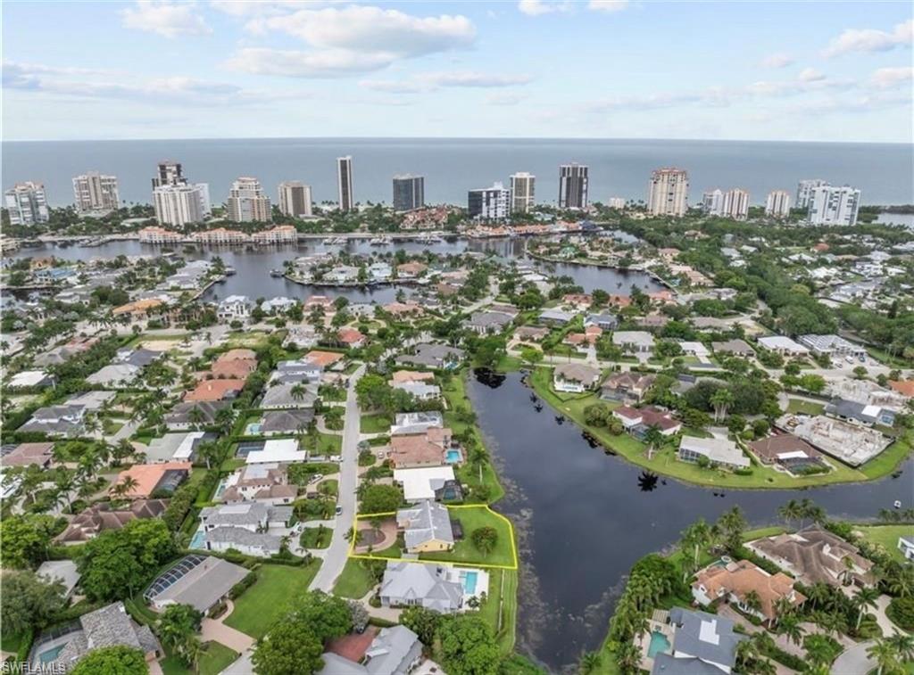 Heavenly views await you at 497 Devils Lane in Naples Florida! THE BEST LOT AVAILABLE ON A RARE LAKE IN PARK SHORE! Discover the unparalleled potential of this hurricane damaged gem perfectly poised for a breathtaking transformation. This original family owned property is nestled on an OVERSIZED PREMIUM LOT of 12,600 square feet, the property offers a serene RARE LONG LAKE VIEW that promises tranquility and beauty at every glance. Located on one of Park Shores quietest and most coveted streets, it is just a leisurely bike ride away from the charming Venetian Village and upscale Waterside Shops, Naples downtown 5th Avenue, blending convenience with an idyllic lifestyle. As a future homeowner you will enjoy membership to the exclusive Park Shore Beach Park, a private oasis featuring crystal sugar sand, restrooms and a delightful picnic area. Though the home is being sold "As-Is" for lot value, the real allure lies in the incredible redevelopment opportunities that await. Magnificent Eagles frequent this lake and a historical rare Glenn Mango tree on the property produces delicious Mangos. Seize the opportunity for a long-awaited, long lake view piece of paradise on Devils Lane, where the promise of a heavenly retreat is right at your fingertips. Survey, lot study and potential future home rendering are available. Schedule your private showing today!