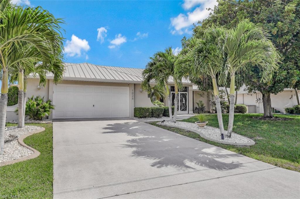Open House Saturday 5/1/2021 1 to 3PM - Enjoy the afternoon sun from the swimming pool or lanai of this landscaped Southern exposure Cape Coral Gulf Access Home near intersecting canals. For those seeking the ability to travel by boat or automobile to the nearest amenities the location is ideal. The home has Metal roof installed (2015), Hurricane shutters, it's also located in Zone-X Flood Zone (No Flood Insurance Required). Home Features Include: 3 Bedrooms 2 updated Baths, den/office near the french entry doors with screened front entry. Large Master Bedroom with master retreat and elegant master bath with oversized shower, 2 Car Garage, Swimming Pool with heater and enclosed swimming pool cage. Travertine tile Floors and oversized floor trim in the main living, kitchen and dining areas, Designer center island kitchen with custom white cabinets, granite countertops, large pantry, formal dining and morning breakfast area. For the boating enthusiast the home features a 10,000 pound boat lift, walk around composite boat dock with canopy, water and electric available at boat dock all nestled on an oversized 80X145 lot with fenced with privacy back yard.