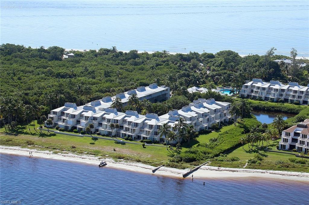 Easy-living ground-level split-plan just one tier back from the bay & only 29 steps to that beach! Convenient east-end location, handy to fishing pier, bike path, marina, & the shops of olde Sanibel. Tropical views to San Carlos Bay from living room, master bedroom, & former center terrace that is now enclosed as 2nd living room or den. Updated eat-in kitchen with hard-surface countertops & white cabinetry. Separate utility room with full-sized washer & dryer, plus interior & exterior owners' storage closets. Community pool, tennis courts, & clubhouse with full kitchen & party room. Storage for bikes too. Rental rules are 30-day minimum with only 3 rentals allowed per year, so this is now a residential community.