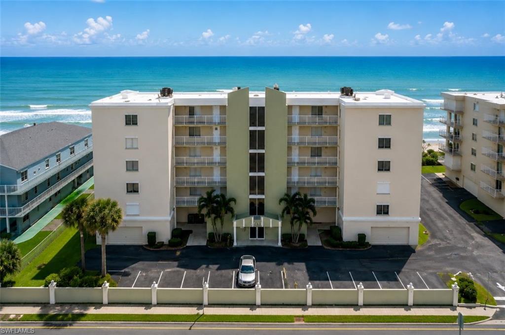 Experience luxury coastal living in this exceptional direct oceanfront corner residence featuring breathtaking panoramic views and the rare convenience of two under-building garage parking spaces. This beautifully updated 3-bedroom, 2-bathroom condo offers the perfect combination of comfort, style, and stunning oceanfront scenery. Wake up to spectacular sunrises from the primary suite and enjoy direct access to the oversized wraparound balcony from both the primary bedroom and spacious living area. The thoughtfully upgraded interior features a newer A/C system, hurricane-impact windows and sliders, accordion shutters, newer carpeting in the bedrooms, a dual-temperature oven, elegant quartz countertops, and custom maple cabinetry throughout. Unique design elements such as striking white pine ceilings and designer sun-blocking window treatments add warmth and sophistication to the space. A private office with built-in workspace and its own separate balcony creates an ideal setting for remote work while enjoying beautiful ocean views and coastal breeze. Impeccably maintained and move-in ready, this stunning oceanfront residence offers an unparalleled opportunity to enjoy resort-style beachfront living as your annual rental.