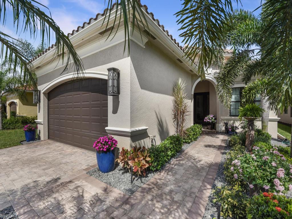 Welcome Home to this beautifully manicured lake view home on an oversized lot in Riverstone, a gated community!  This Tribeca floor plan boasts 10' ceilings, coffered ceilings in entryway and master bedroom, open concept living with 3 spacious bedrooms plus a den all loaded with generous upgrades!  Master bath is beautiful with soaking tub, separate shower, and dual vanities. No expense was spared with custom Hunter Douglas window treatments, polished tile floors, crown molding, upgraded exquisite light fixtures throughout, professionally painted home and lanai it is better than new!  Step into the elegant foyer leading to the spacious light filled living space with relaxing views of the lake.  With an additional large dining room adjacent to the kitchen, this home is the perfect place for entertaining.   There is plenty of room for a pool if you so desire.  The amenity campus at Riverstone offers a vacation-inspired lifestyle for all ages.  Tennis, pickleball, basketball, tot-lot, social hall, cabanas by the pool, hot tub, resort and lap pool with a full time activities director.