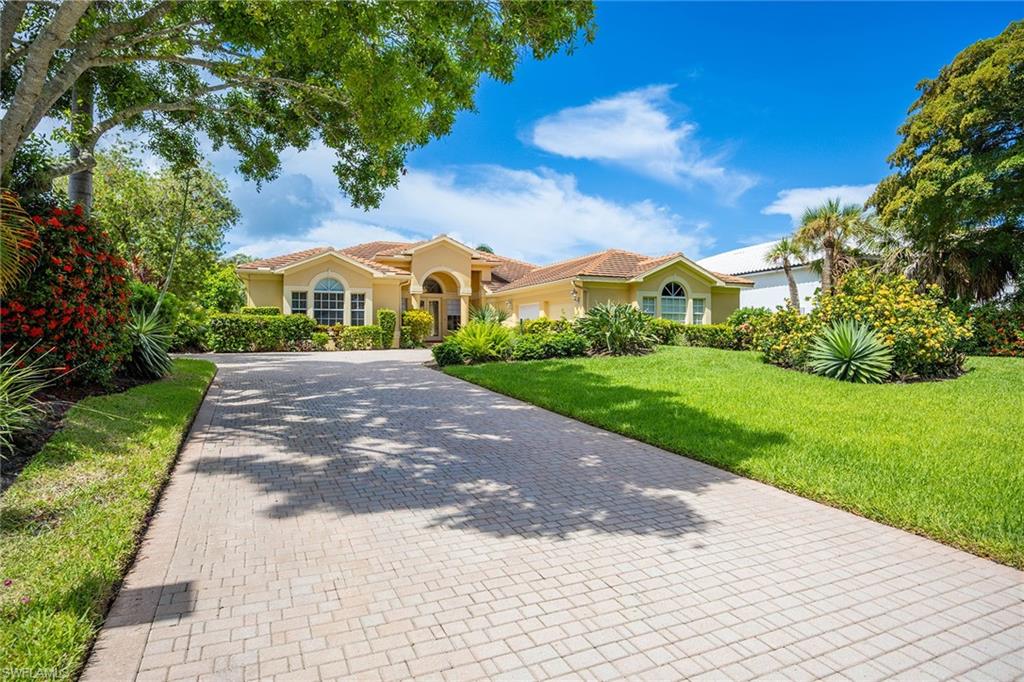 Welcome to this 4-bedroom, 3-bath waterfront residence offering privacy, spacious living, and effortless Florida lifestyle just minutes from US-41, and Barefoot beach!  The open-concept layout features a large great room and expansive foyer flowing into a gourmet kitchen with premium appliances overlooking the spa and infinity-edge pool. Enjoy indoor-outdoor living with a private lanai, pool, spa, and dock, perfect for relaxing or entertaining. Complete with state of the art appliances through the home,two-car garage and dock off of Spring Creek Ready for immediate annual occupancy, this home offers comfort, convenience, and a serene Florida setting.