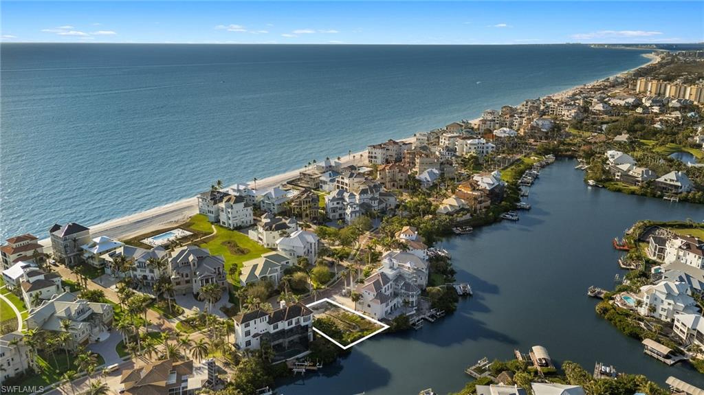 Rare opportunity to build your dream home on the Bay in North Naples’ prestigious Barefoot Beach Community. This exceptional lot offers a unique chance to craft your ideal coastal sanctuary, featuring stunning bay views and the potential for Gulf vistas from the upper levels. Perfectly situated for beach and boating enthusiasts, this property is just a 2-minute walk (0.1 miles) from the “resident only” deeded beach access and offers direct Gulf access—no bridges—minutes away from your future boat dock and lift. This gem offers the perfect canvas to build your custom residence, designed to your exact specifications and incorporating the latest building codes. The lot allows for the potential of a 5,000 sq ft home, and comes with a sample architectural sketch, offering a vision of what’s possible on this prime, rarely available property. The OPTIONAL in-community “Club at Barefoot” offers tennis, 2 restaurants, beachside food/bev/chair service & activities. Nearby to fine dining & easy access to RSW Airport, Mercato & Waterside Shops. Only 15 miles to Naples 5th Avenue. This is your chance to create the ultimate bayfront retreat in Barefoot Beach.