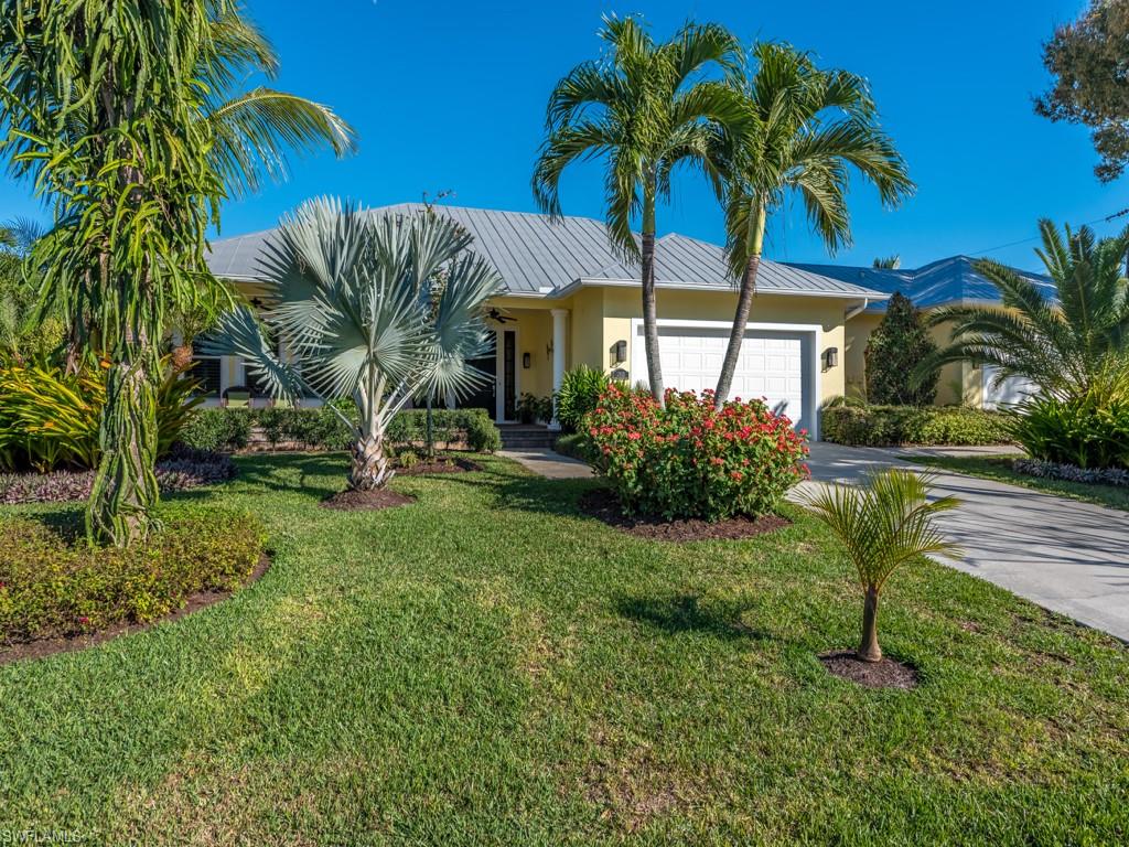 Beautifully updated home on 3 lots with a pool and 4 car garage, close to Old Naples and the bay, spectacular gardens, here is the home  you  have been waiting for in Naples.
 A courtyard home with all the rooms opening onto the lanai and pool and two 2 car garages! Built in 2003 and lovingly upgraded by current owners, Improvements include: new kitchen with quartz countertops, new baths, bamboo flooring, newly painted inside and out, plantation shutters throughout, new a/c, new sound system, security system, new screening on all windows and a buried propane tank to feed the generator. Den/office opens onto the lanai and is the perfect spot for privacy for those who work from home.
Grounds are spectacular, as though you have your own small botanical garden. Close to Old Naples and the beaches. Boat slips available for rent or purchase close by.