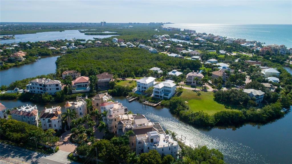 2019 NEW CONSTRUCTION luxury home built by Distinctive Development Group (DDG) is perfectly located in double-gated Southport on the Bay in North Naples’ premier community of Barefoot Beach. Beach & Boaters delight: the Gulf of Mexico with deeded beach access for residents is a short walk away, while direct Gulf access (no bridges) is 10 minutes from your boat dock & lift. Relax & unwind on 2 entertainment decks, with pool/spa, ample lounging areas & outdoor kitchen & grill. Brimming with natural light this coastal contemporary retreat offers a wide-open floor plan with 4 bedrooms + den/office (all beds with en suite baths), chef’s kitchen with Wolf appliances, 3-car garage & so much more. Stunning finishes include 12’ ceilings, hardwood floors, custom cabinetry with granite & quartz slab counters, butler’s pantry, private elevator, wood plank accent wall features, wood beam accents & more. This concrete block home is built to the newest codes with 170 mph PGT impact glass windows/sliders. Mercato & North Naples’ amenities are close at hand, with easy access to RSW International Airport. This gem is a must-see!