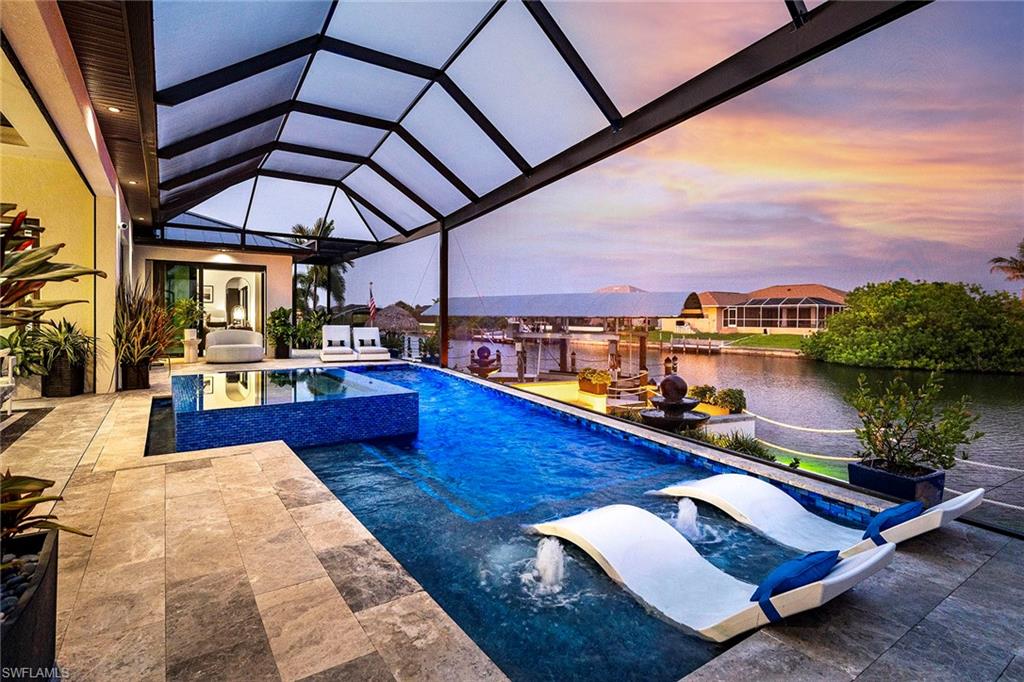 Award-winning 2023 custom Gulf-access estate featuring 153 feet of waterfront and recipient of 13 Parade of Homes Awards, showcasing exceptional craftsmanship, luxury finishes, and cutting-edge design. This one-of-a-kind residence was built for waterfront living and entertaining at the highest level.

The chef’s kitchen is a showpiece, featuring Sub-Zero and Wolf appliances, a 13-foot island, floor-to-ceiling custom cabinetry, Caesarstone countertops, wine refrigeration, and a dedicated beverage center. Interior finishes include imported Italian porcelain flooring, Level 5 smooth walls, Montana oak ceiling accents, custom architectural ceilings, and designer lighting throughout.

The luxurious primary suite offers a spa-inspired seven-head shower and custom Closet Factory organizers. Additional features include impact-resistant windows and doors, remote hurricane shutters, whole-home automation, a 24,000-watt Generac generator, and a 500-gallon buried propane tank.

Outdoor living is truly unmatched, featuring an air-conditioned lanai, fully equipped outdoor kitchen, infinity-edge gas-heated pool and 12-person spa, fire pit, private tiki hut, beach area with gazebo, and a custom dock spanning the full width of the property with a 10,000-pound boat lift.

Completing this extraordinary waterfront estate is a climate-controlled garage with custom cabinetry and built-in storage. Offered turnkey at $2,499,000, this is a rare opportunity to own one of Cape Coral’s most celebrated luxury waterfront homes.