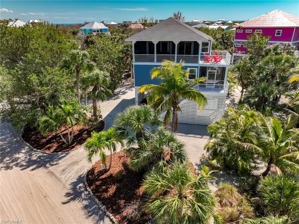 Exceptional Double-Lot Island Retreat! Ideally positioned on a rare double lot, this beautifully maintained North Captiva Island home offers enhanced privacy, extra space, and low-maintenance coastal living.
This North Captiva retreat offers more than just a home; it presents a rare opportunity for the lucky buyer to own an exclusive separate membership in Captiva Castaway Beach. Just a short, scenic stroll from your front door, this membership grants you deeded access to arguably the finest 'sugar sand' private beach on the island. Enjoy this ultimate Gulf-front luxury beach with its pristine, secluded shoreline reserved for a select few, ensuring your piece of paradise remains private and protected for years to come.
Designed with a reverse floorplan, the home is filled with natural light and opens to lush tropical surroundings. The main living area, with its full-length sliding glass wall, allows the inside to flow seamlessly onto a spacious screened lanai (with premium “no-see-um” screen comfort) for bug-free open-air entertaining, lounging on the double hammock, or just enjoying the soft gulf breezes, creating indoor-outdoor living ideal for any occasion. The galley-style kitchen features a generous dining bar and walk-in pantry, while two private primary suites with en-suite baths and walk-in showers offer comfort and privacy. A versatile bunk room serves as a fourth sleeping area for additional guests.
Extensive exterior “maintenance-free” recent upgrades set this home apart:  impact-resistant doors and sliders, PGT energy-efficient low-E impact windows, composite decking, powder-coated aluminum railings, and premium composite siding (rated for up to 150-mph winds) that you never need to paint! Additional improvements include a new roof with transferable warranty, energy-efficient HVAC systems with Wi-Fi thermostats, and updated appliances—delivering durability and low-maintenance ownership so you can spend more time on the beach and less time working on your house.
Let your imagination wander! Create your personalized island paradise, as the adjacent surveyed lot, cleared free of Brazilian pepper, provides valuable flexibility—ideal for lush gardens, a swimming pool, a 2nd guest house or creating an even larger private compound. Conveniently located near the beach access, ferry landing, and island amenities, this property has a history of strong rental potential. 
A rare opportunity to own a double-lot island home with upgrades, privacy, and expansion potential—all offered well below reconstruction cost.
Schedule your private showing today and experience the island lifestyle firsthand!