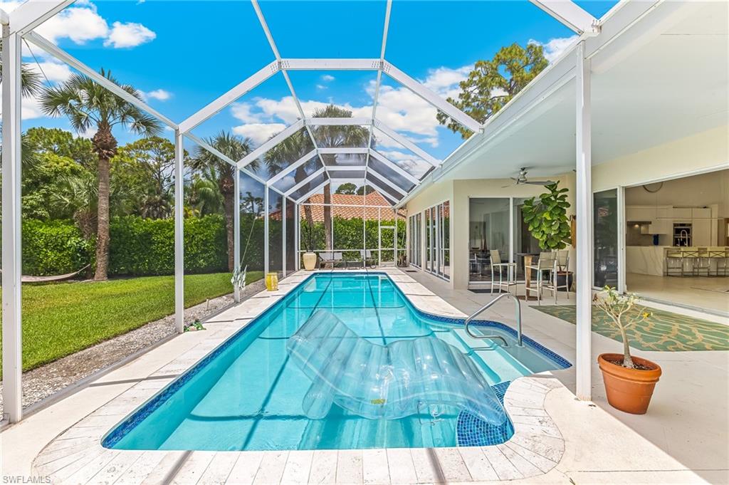 Situated on nearly 1/2 an acre within the prestigious Imperial Golf Estates, this exceptional single-family residence combines modern design, sophisticated décor, and an impressive sense of scale. Offering an outstanding opportunity to enhance and tailor the home to today's preferences, the property is ideally positioned for a buyer seeking both value and potential in a premier Naples location. A welcoming circular driveway and desirable southern exposure create outstanding curb appeal while filling the home with natural light throughout the day.

The grand living room serves as the centerpiece of the residence, showcasing soaring ceilings reaching up to 18 feet and dramatic pocketing sliding glass doors that disappear completely from view, creating a seamless transition between indoor and outdoor living. The adjoining breakfast room also features disappearing sliders, allowing both spaces to open fully to the expansive lanai and capture beautiful views of the lush grounds beyond.

Designed for both comfortable everyday living and elegant entertaining, the spacious floor plan offers a refined yet inviting atmosphere. The luxurious owner's suite is a private retreat, complete with a sitting area that provides the perfect space to relax and unwind. Guests are equally well accommodated with a generously sized suite featuring its own separate sitting room and private bath, while a third bedroom enjoys ensuite accommodations, ensuring comfort and privacy for family and visitors alike.

Surrounded by expansive green space, the property offers an exceptional sense of privacy rarely found within a gated golf community. The oversized lanai serves as a true outdoor oasis, highlighted by a large pool and abundant space for lounging, dining, and entertaining. With its southern exposure, the outdoor living area enjoys abundant sunshine throughout the day, making it the ideal setting for enjoying Southwest Florida's year-round lifestyle.

Blending contemporary elegance with timeless comfort, this remarkable Imperial Golf Estates residence presents a rare opportunity to enjoy estate-sized living, modern luxury, and seamless indoor-outdoor living in one of North Naples' most desirable communities.