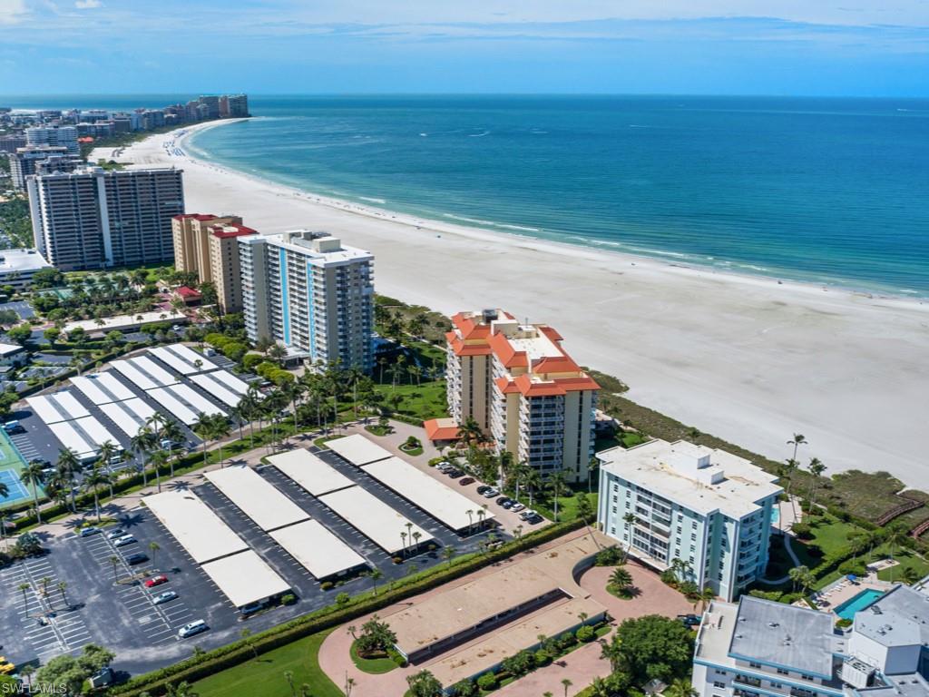 Stunning, completely remodeled, beachfront residence offers island and partial Gulf views from the private balcony. This light and bright 1 bedroom, 1 and a half bath residence features luxurious finishes and upgrades throughout including porcelain tile flooring and Hunter Douglas window treatments. The kitchen will delight any chef with ample cabinetry, soft close cabinets and drawers, stainless appliances, and contemporary counters and backsplash. The living space opens to the balcony, the ideal place to relax and unwind while feeling the gentle island breeze. The master suite boasts access to the balcony and en-suite bath with spacious walk-in closet, gorgeous cabinetry, and walk-in shower featuring Grohe fixtures and custom tilework creating a spa-like ambiance. Enjoy extra peace of mind with impact windows and doors and recently updated electric. New air conditioner installed in 2025 with a transferrable 5-year parts warranty.  Additional storage locker and common laundry facilities on every floor. Tradewinds offers lush, tropical landscaping, a secured lobby with on-site manager, social room with kitchen, grill area, vehicle wash, and private beach access. The large pool area is currently being remodeled and will have all new pergolas and outdoor furniture. Tradewinds is centrally located near shopping and restaurants. Do not hesitate to make this phenomenal residence your own piece of paradise.