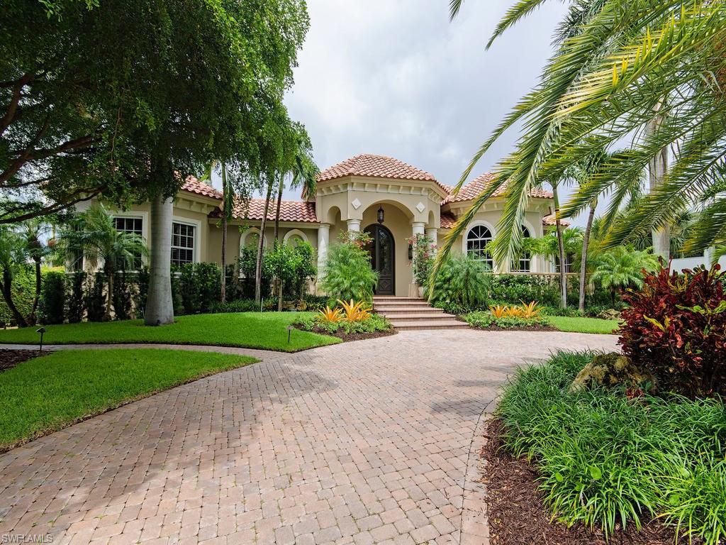 PRICE REDUCTION. $20,000 Painting/Decorating Allowance. Enchanting courtyard styled home situated on large lot, steps away to the Gulf of Mexico. Enter through wood iron doors into the expertly designed courtyard for outdoor living complete with heated resort style pool, spa, outdoor kitchen and shower. Main home is great for entertaining & features remodeled gourmet kitchen & cook top, wall oven, stainless appliances, opens into the grand great room.Gas fireplace and 2 dual zone wine refrigerators. Spacious main house incorporates 4 bedrooms, 3 1/2 baths, office/den, large formal dining/living room, eat-in kitchen, 3 car garage. Master bedroom suite is located downstairs, an en-suite guest bedroom. Upstairs has 2 bedrooms, full bath, living area and kitchenette, great for guests, live-in nanny, or in-laws There are countless details to this home including tray ceilings, tile floors, grand custom made fireplace mantle,and security system Let's not forget the 1 bedroom and 1 full bath cabana. Alley in the rear of the property to enter privately into the garage. All of this and more within walking distance to the beach and 5th Ave known for Naples top restaurants and shopping.
