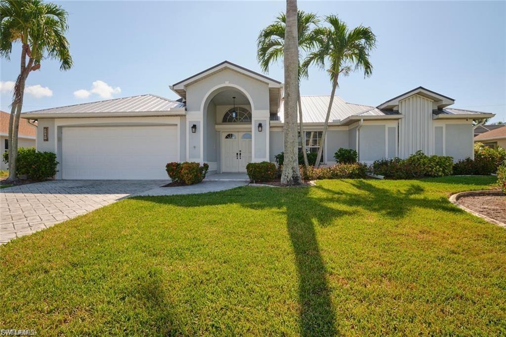 Location Location Location, SURROUNDED by million-dollar plus homes. This 3-bedroom, 2-bathroom home is in a prime location JUST Walking distance to Cape Harbor! 5-star dining and shopping at your fingertips! This gorgeous home has upgraded landscaping and custom concrete drive gives it the perfect curb appeal. Upon entering the home, you will notice the soaring ceilings, The kitchen has been completely updated with real wood cabinets, granite counter tops, stainless steel appliances and a large breakfast bar. The master bedroom is spacious and bright with a completely renovated on-suite; double vanity, jetted tub and walk in shower all with access to the screened Lanai This home is perfect for entertaining, with a large formal living and dining as well as a more casual great room with fireplace, all with easy access to the lanai and large fenced in yard. Some of the upgrades I haven't mentioned: Metal Roof gorgeous real hardwood floors and roll down shutters. Do not miss your opportunity to live the fine life in this stunning home!