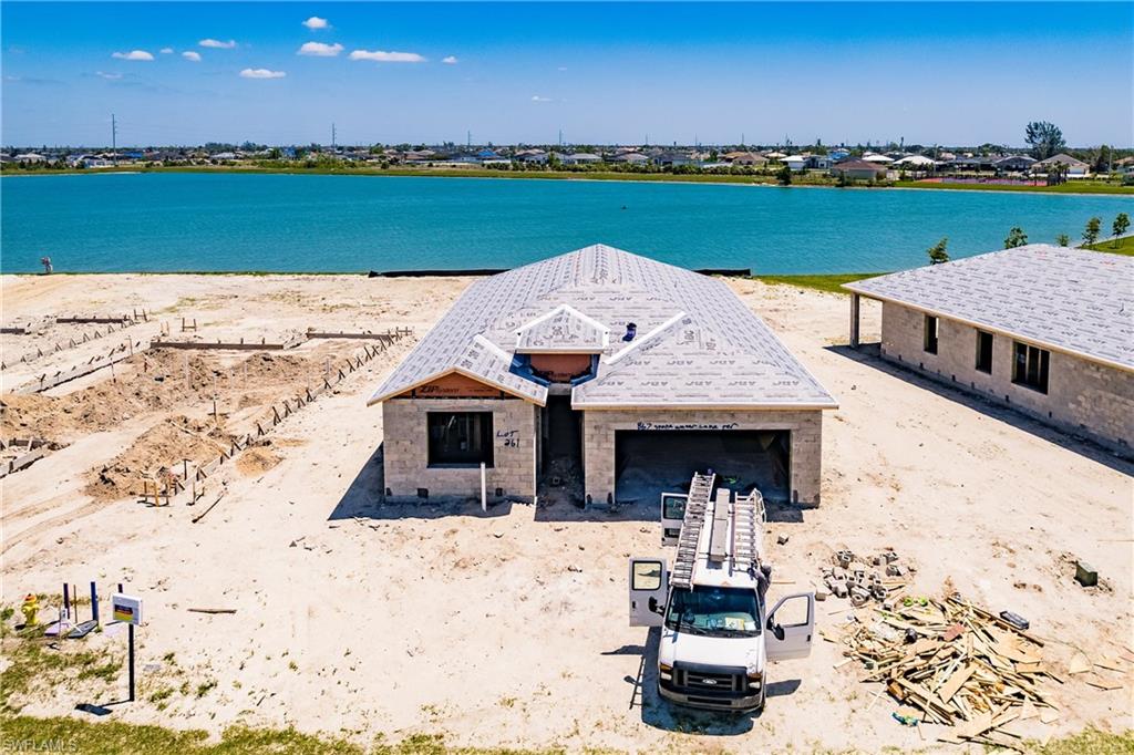 Enjoy the Water Views in you beautiful Brand New Lakefront Home in Stonewater, Cape Corals newest gated community! The Delray Model is a 4 Bedroom single level home with a split bedroom floor plan. This one is all decked out with tons of upgrades including 42 inch Barnett Linen cabinets, Level 3 granite countertops, Brick Pattern Horizontal Backsplash, Stainless Steel Appliances, 8 ft interior and exterior doors with upgraded Base and Casings, Staggered Tile Floors throughout the main living Area, Tiled Showers, and Screen enclosed Lanai Overlooking 50 Foot Deep Lake! Community features include a community pool, fitness center, tot lot, tennis and pickleball courts. This Gem is Expected to be ready to move into in October 2023 and Builder is Currently offerring buyer $13,000 Closing Cost Credit, Certain Terms Apply and Subject to change. PHOTOS OF FINISHED HOME ARE MODEL HOME WHICH IS AVAILABLE TO SEE ON SITE AND COLORS, FINISHES AND UPGRADES WILL VARY FOR THIS HOME!