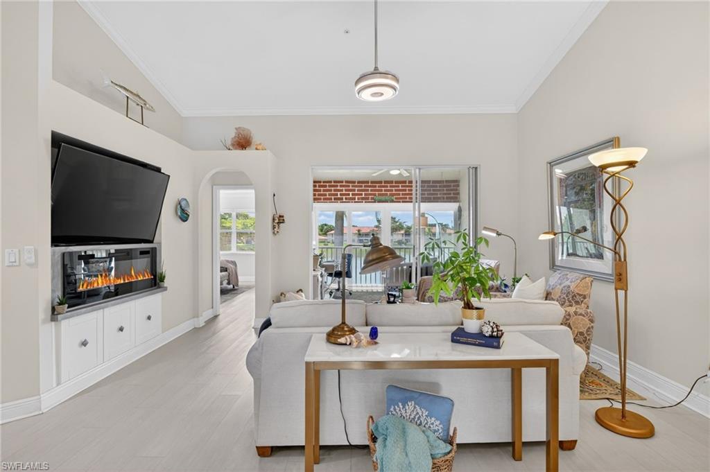 This remodeled second-floor residence in the gated Huntington Lakes community offers a two-bedroom-plus-den layout, with a fully enclosed, climate-controlled lanai that serves as a den overlooking the community lake. The interior features crown moulding, vaulted ceilings, and laminate and tile flooring throughout. The primary suite includes a separate soaking tub and walk-in shower. Eastern rear exposure brings abundant natural light and morning sunrise views over the water, and the home includes a detached one-car garage. Community amenities include three pools, a clubhouse with fitness center, and tennis courts. Within an A-rated school district, minutes from Seed to Table, Founders Square, and Mercato.