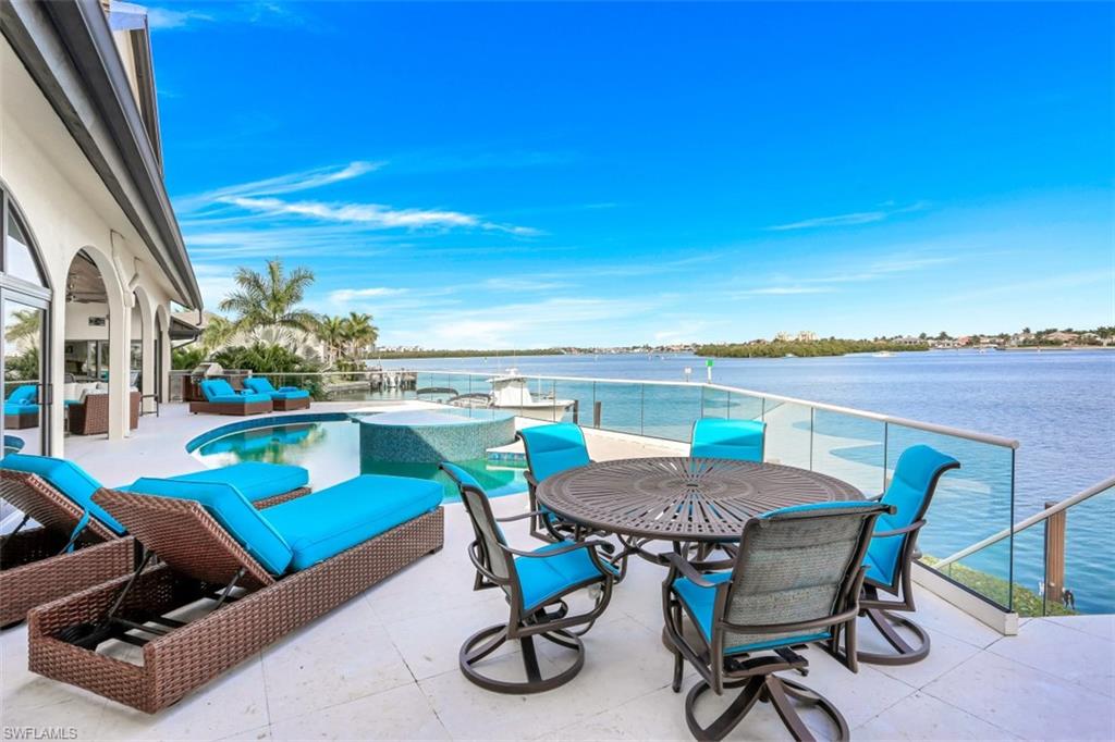 VIEWS VIEWS VIEWS!! and BOATERS DREAM! 172 feet of panoramic views on the bay! This spectacular residence was completely renovated in 2016! All impact rated windows and doors * custom floating staircase, open kitchen, great room floor plan including a walk behind wet bar- Master suite with sliders out to private patio * dual walk in closets, Marble bath with walk in shower, soaking tub and dual vanities.. 2 large guest suites on the main level and a private suite on the upper level with a private balcony.. Fantastic covered lanai space, pool with raised spillover spa, outdoor kitchen and plenty of sun deck to soak up the rays! This home is ideal for entertaining!! Boat Dock with 2 lifts PLUS Shore power and dockage for a 110 Ft Motor Yacht .. NEW METAL ROOF 2020