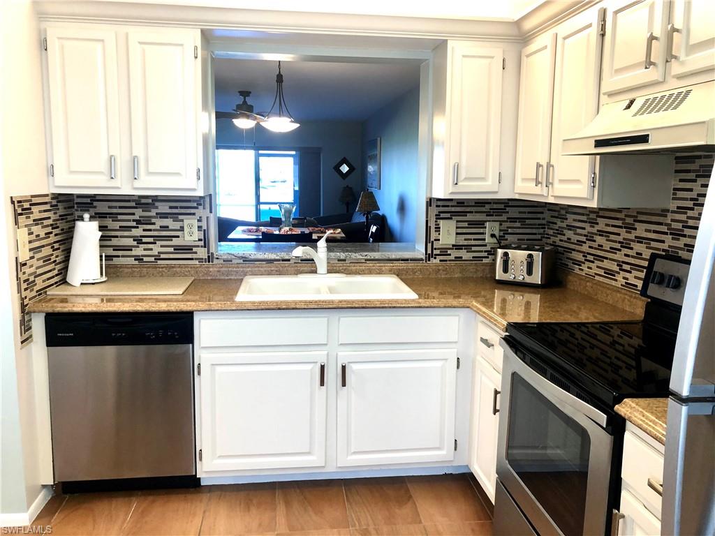 This updated First Floor 2 bedroom 2 bath unit is in the much desired St. Andrews building which is next to the Clubhouse and Pool.  The extra large lanai overlooks the 1st hole of the 9 hole golf course as well as the beautiful fountain lakes. Low HOA fees include unlimited free golf, water, sewer and basic cable.  There is tile flooring throughout and the beautifully updated  kitchen includes stainless steel appliances and granite countertops with a glass backsplash.   Lots of storage including an outside storage closet. Golfview Golf and Racquet has 2 pools overlooking the lake, a satellite pool, clubhouse with lots of activities, tennis, pickleball and shuffleboard.  This great location is close to beaches, shopping, restaurants, and Dr.'s offices