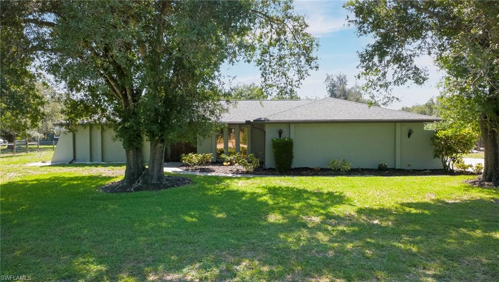 Calling anyone looking for room to spread out both inside and out! A rare acreage opportunity is ready and just missing one thing...you! This beautifully constructed concrete block home is situated on 1.21 acres in a quiet & animal friendly neighborhood, offering the space, privacy, and freedom that's becoming increasingly hard to find. Best of all, NO FLOOD INSURANCE is required, providing added peace of mind and potential savings. Step outside to your own private backyard retreat featuring a heated, oversized volleyball-style pool with center drain for equal-depth sides—perfect for year-round swimming, entertaining, or simply relaxing. The expansive lanai area offers the ideal spot to enjoy the shade, dine poolside, or unwind while overlooking the spacious backyard.
Inside, quality diagonal tile flooring flows throughout the home for both style and easy maintenance. The bright, spacious kitchen is appointed with granite countertops, stainless steel appliances, modern hardware, and a pantry. A thoughtfully designed split-bedroom floor plan includes four bedrooms and three full bathrooms, with two guest bedrooms featuring pocket doors to create private guest suites for family or visitors.
The 1.21-acre property also boasts mature trees and plenty of room to expand your tropical oasis with additional trees, fruit trees, gardens, or outdoor amenities. This exceptional property combines acreage, privacy, and resort-style living—all with the added benefit of no flood insurance required. Roof replaced in 2021, HVAC 2024, Septic upgrades 2023, fenced in on 3 sides of the property 2024, new pool heater 2022!