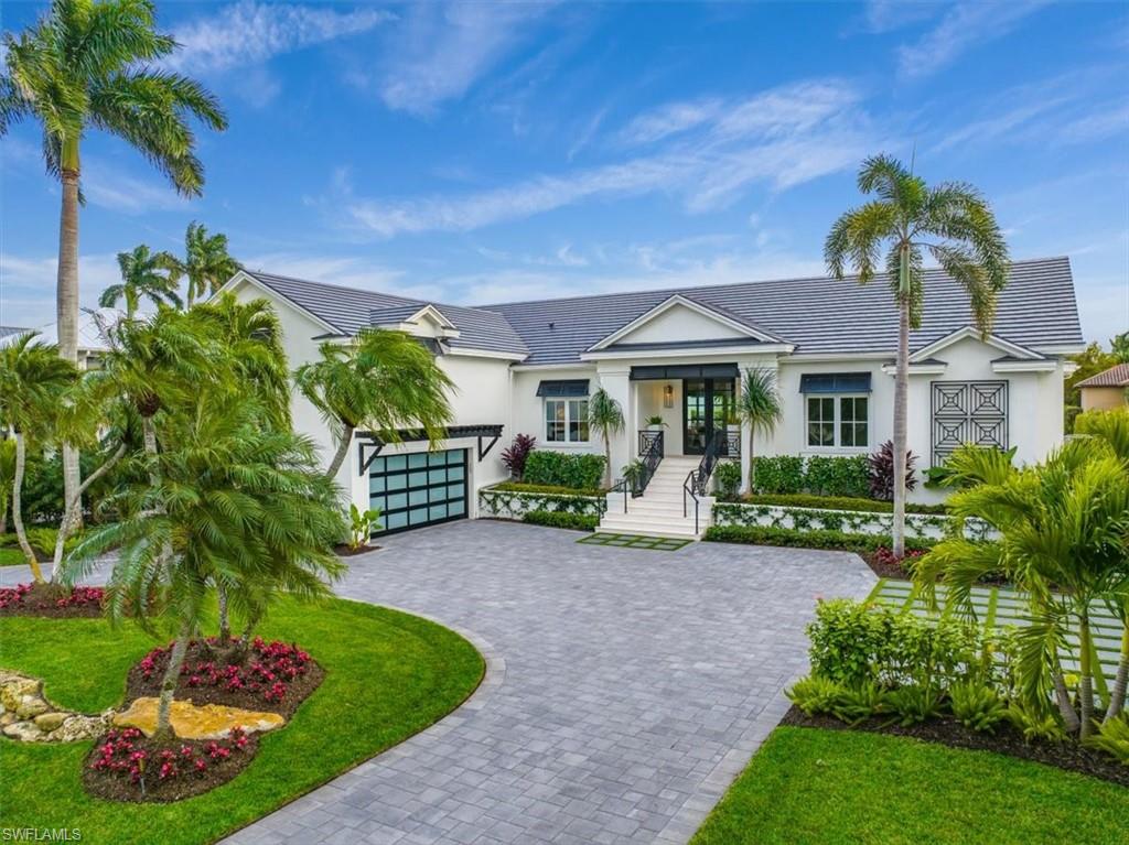 MOVE-IN READY, ENTIRELY REMODELED, WATERFRONT BEAUTY IN AQUALANE SHORES! This elevated coastal chic boaters’ paradise exudes casual elegance and benefits from a 10' Elevation and no interior flooding from recent storms! Every detail was considered in the complete ‘back-to-the studs’ stylish, high-quality redesign and update of the interior and exterior features of this outstanding waterfront property which has been entirely reimagined from its original style and 'lives like new construction'. Coveted Southern exposure and 100’ of waterfront, complete with boat dock, 16,000 lb boat lift and direct gulf access, plus an expansive remodeled pool and deck, outdoor bar, new circular driveway, new roof, new hurricane impact windows, and a new, never-used whole-home generator using natural gas. The home offers spacious covered lanais, perfect for relaxing, outdoor dining and entertaining. The interior upgrade list is extensive, featuring wide-plank European Oak hardwood floors, two kitchen islands, gleaming quartz countertops, a Wolf gas range, Miele appliances plus additional refrigerated drawers, and a 240 bottle temperature controlled wine wall in the elegant living room. The first-floor primary suite enjoys an attached sitting room with water views. Also on the first floor is a tranquil guest suite plus the optional 5th bedroom which can be used as an office or ‘flex’ room. The second level offers two more peaceful guest suites. The spacious air-conditioned 2-car garage provides additional storage for a 3rd car, jet-skis, paddle boards and bikes. Located in walking or biking distance to white sand beaches, sophisticated shopping and dining on 3rd St S and 5th Ave S.