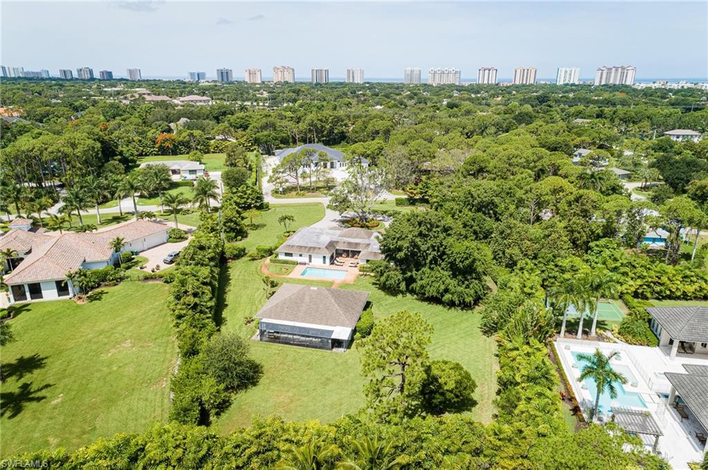 Once you have lived in Pine Ridge its hard to imagine anywhere else! Welcome home to the 2020/2021 REMASTERED sprawling ranch. Situated on 1.24 acres on a highly desired quiet interior lot in Pine Ridge with over 5000 sq ft under air and 2 miles to the Gulf of Mexico! Privacy in the heart of Naples with lush tropical landscaping and curb appeal greets you at the circle driveway. The 3500+ sq ft main residence has a lengthy improvement list with all new flooring, new doors, woodwork, skim smooth coat the ceilings and walls and more! The center of this home is the modern chef’s gourmet kitchen with a waterfall quartz 10’+ island, Subzero/Wolf Appliances, wine tower, 36” freezer & 36” fridge, double ovens and dishwashers and butler’s pantry. The master suite is very spacious with den, walk in closet and upon entering the double doors to the spa inspired bathroom with its amazing natural light, double showers with Brizo fixtures, soaking jacuzzi tub and double sinks. The 2014 guest cabana house is 1500 sq ft under air with 3 screened lanais with many possibilities and uses for guest, office, gym. Fully fenced with mature landscaping and fruit trees (lemons, mango and pomegranates).