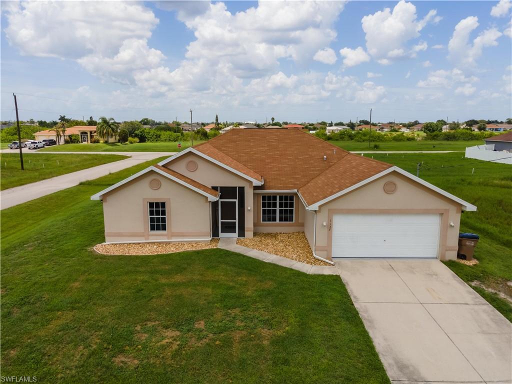 CORNER LOT! Welcome home to this beautiful 4 bedroom, 3 bathroom, 2,113 square foot home located in NW Cape Coral. The home features large vaulted ceilings throughout the main areas of the home with a large open floor plan. The split floor plan features the master suite and guest rooms on opposite sides of the home for owner privacy and convenience. Some additional features of the home include: Screened in lanai with outdoor spa (included), new well pump with warranty, rock landscaping, water softener with reverse osmosis in the kitchen, large open kitchen with breakfast bar style seating, dining/breakfast nook, formal dining room, Jack and Jill style guest bathroom, tub and shower combo in master bath, dual vanity in master suite, large walk in closet in master, spacious laundry room with washer and dryer, large kitchen pantry, wood cabinets and so much more! Enjoy your expansive outdoor yard space with plenty of room to add a pool or fence. Close to schools, shopping and restaurants. Don't wait, schedule your showing before this one is GONE!